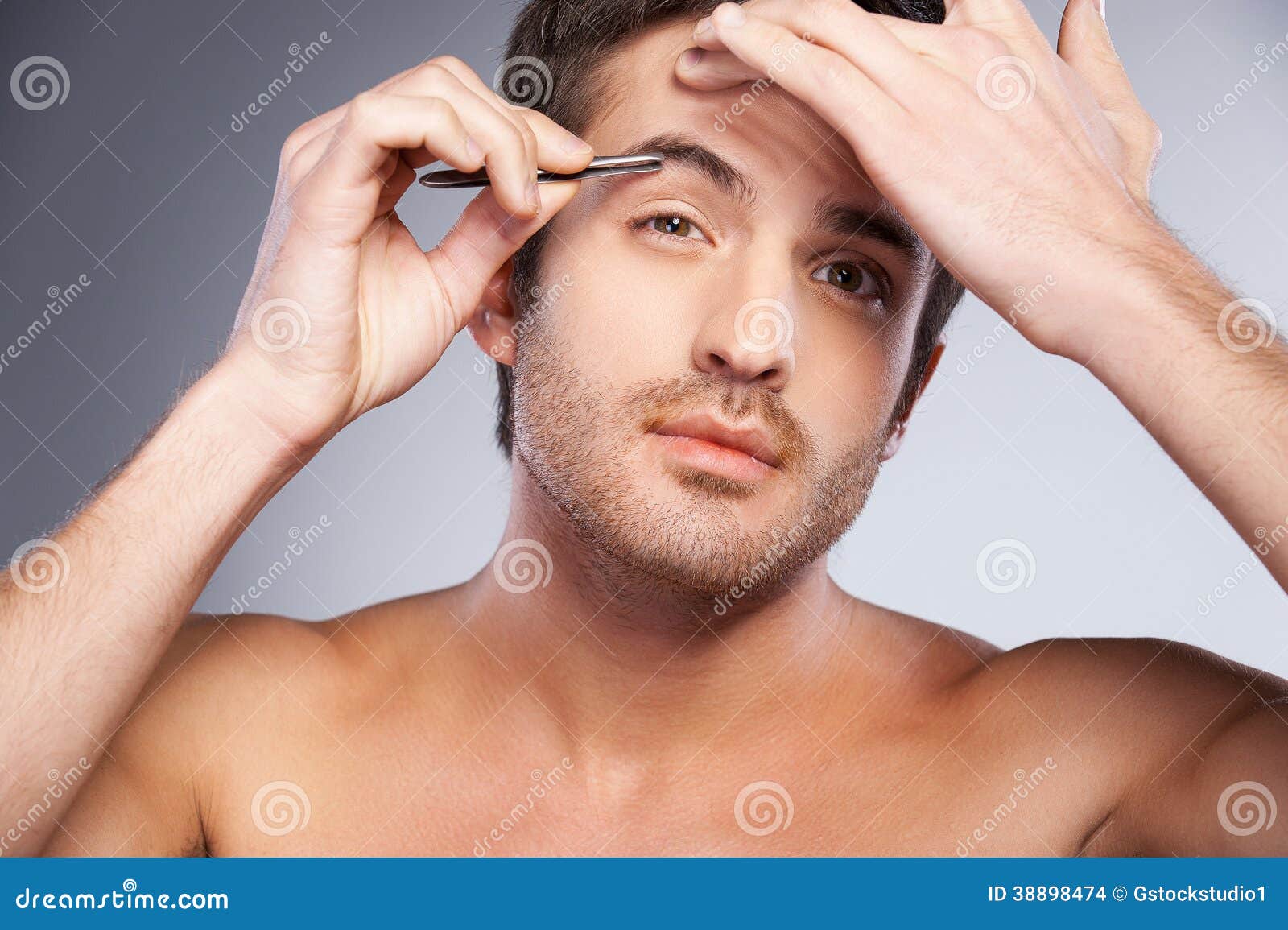 Man tweezing his eyebrows. stock photo. Image of caucasian 38898474