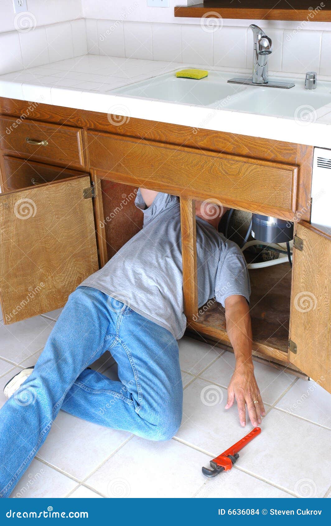 Man Under Sink Reaching for Wrench Stock Photo Image of wrench