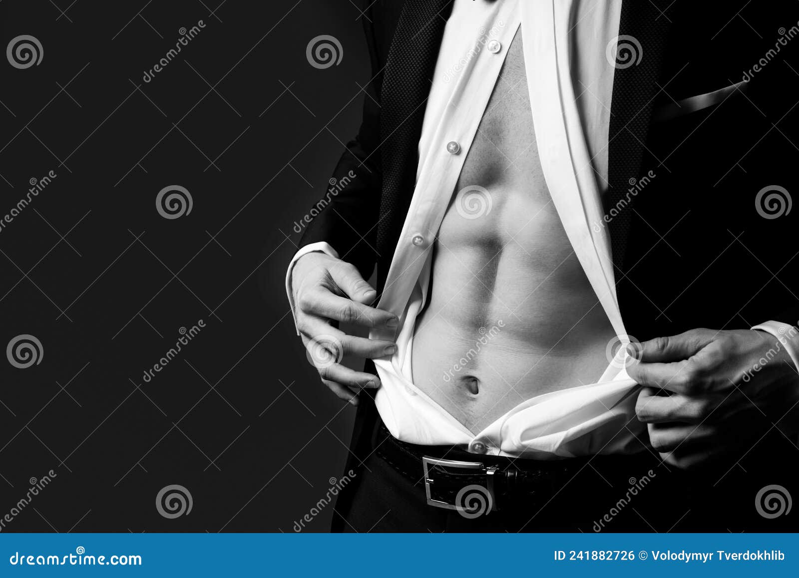 man undress suit. sexy male torso in suit. man shows abs. classic fashion look.