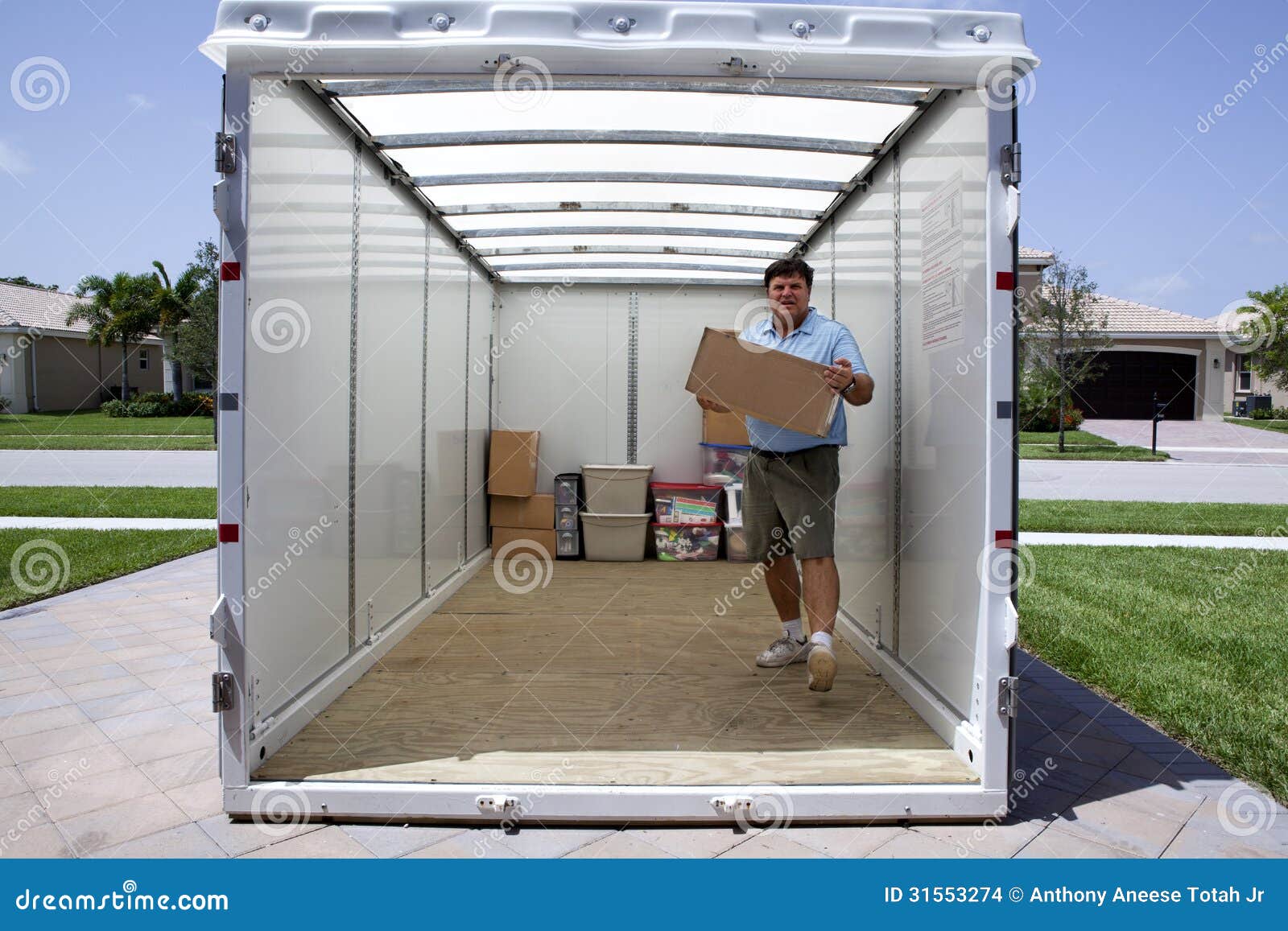 man unloading portable storage unit