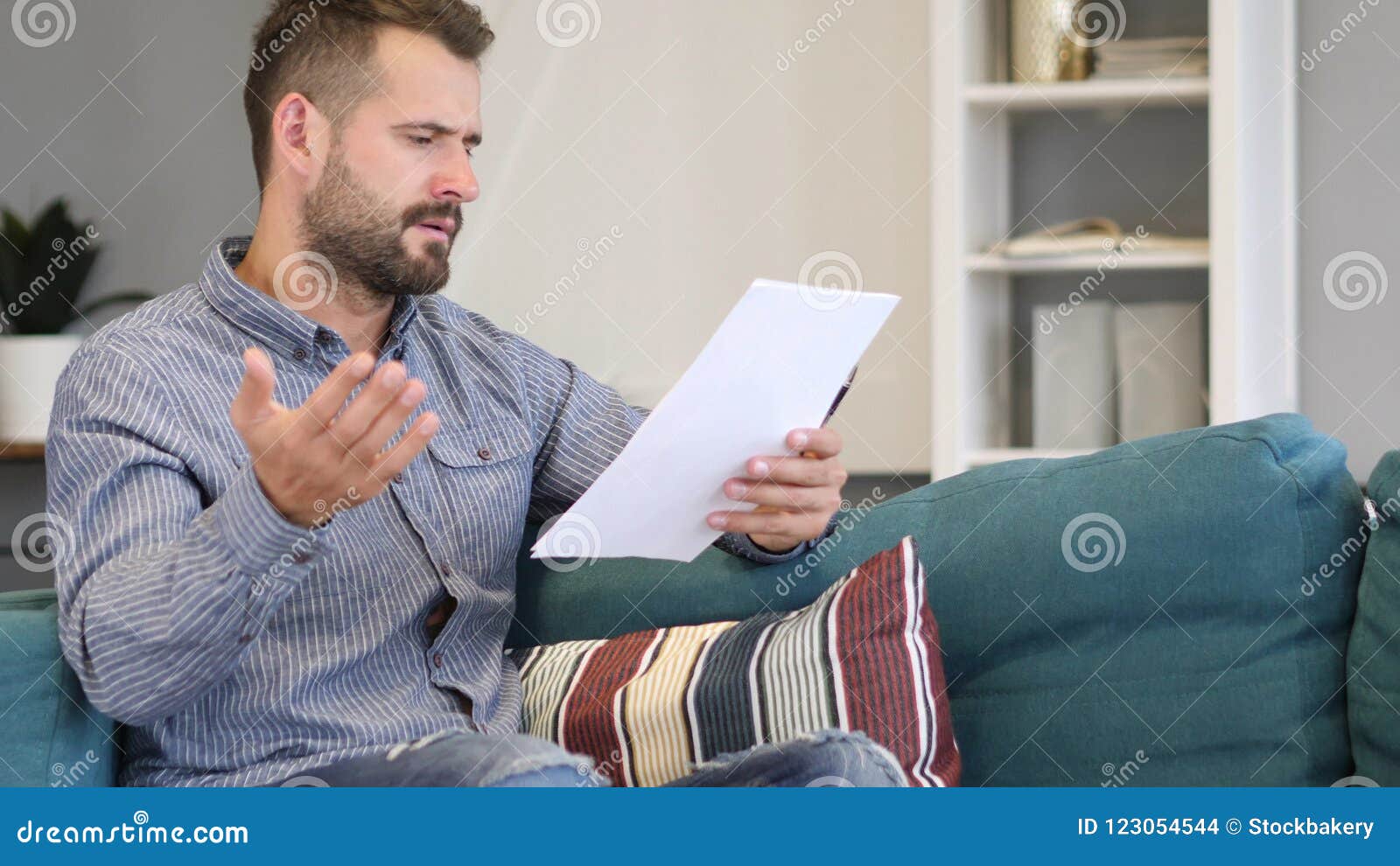 man upset after reading documents, feeling sad