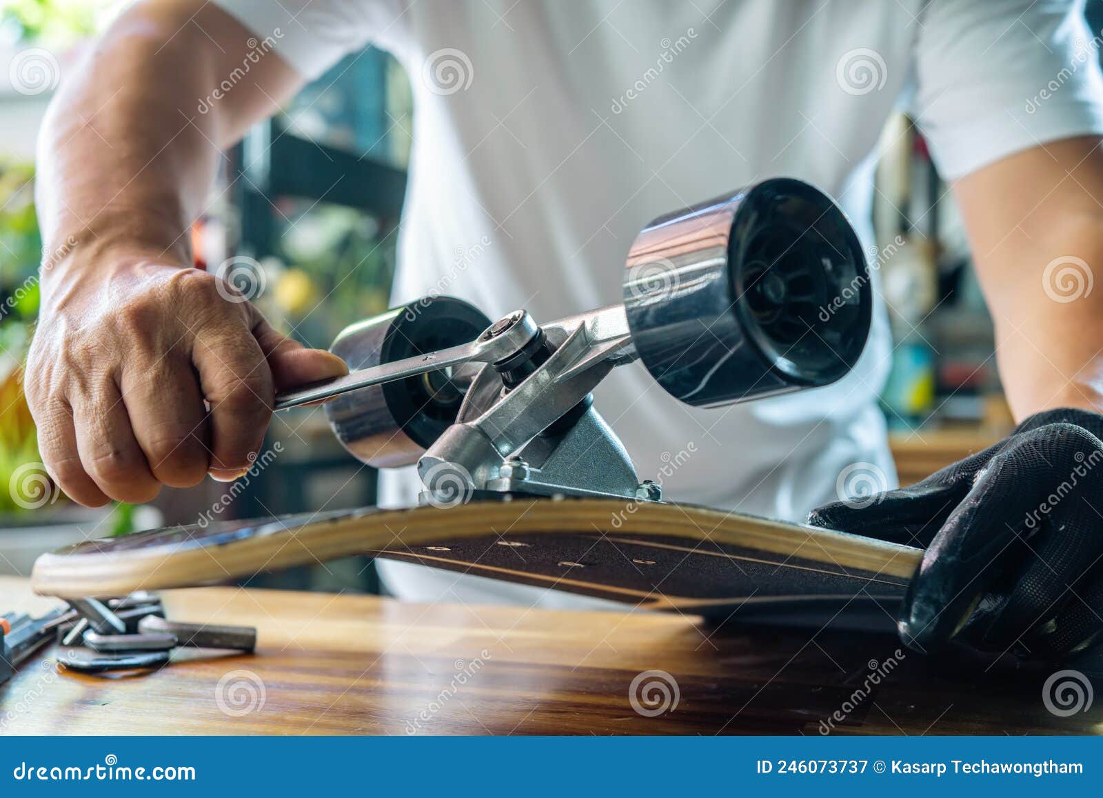 Man Use the Socket Tool To Remove the Nuts on Skateboard and Adjusts