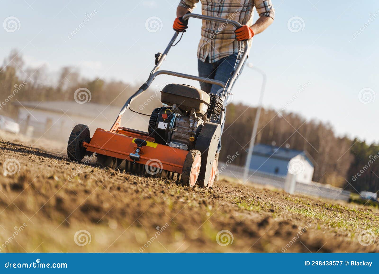 Man Using Aerator Machine To Scarification and Aeration of Lawn or