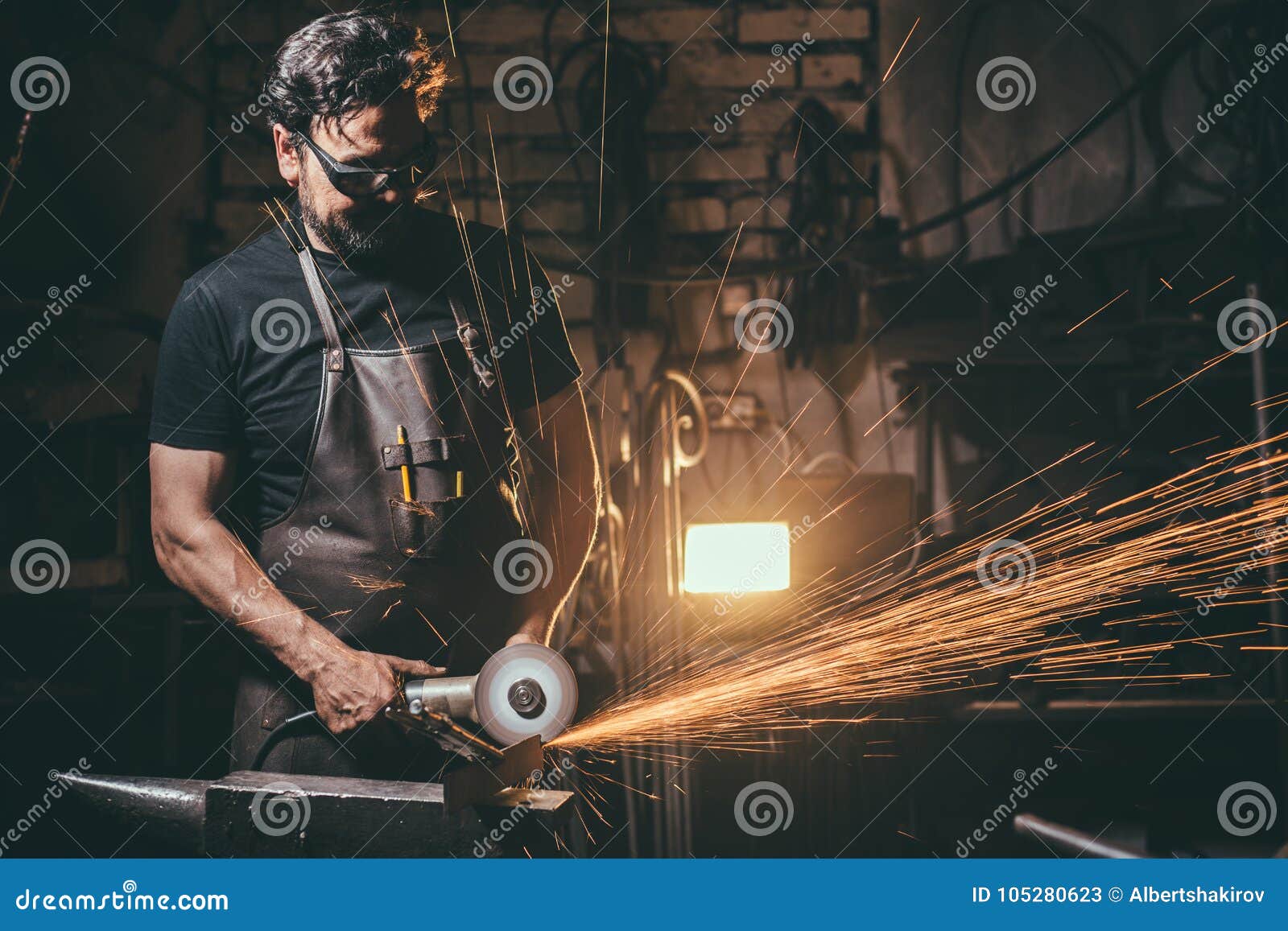 Man Using Angle Grinder in Factory and Throwing Sparks Stock Image