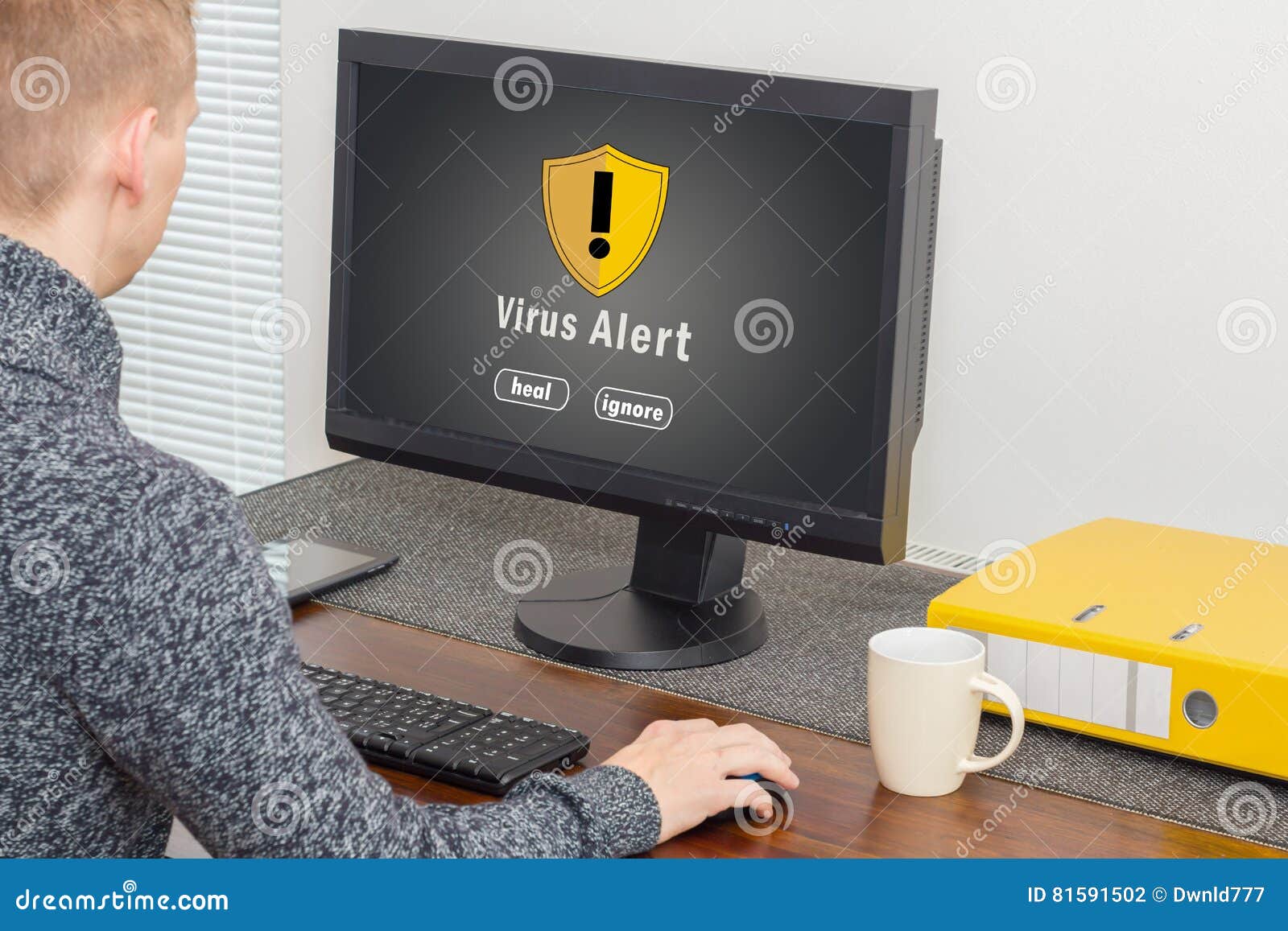 man using computer with computer virus alert