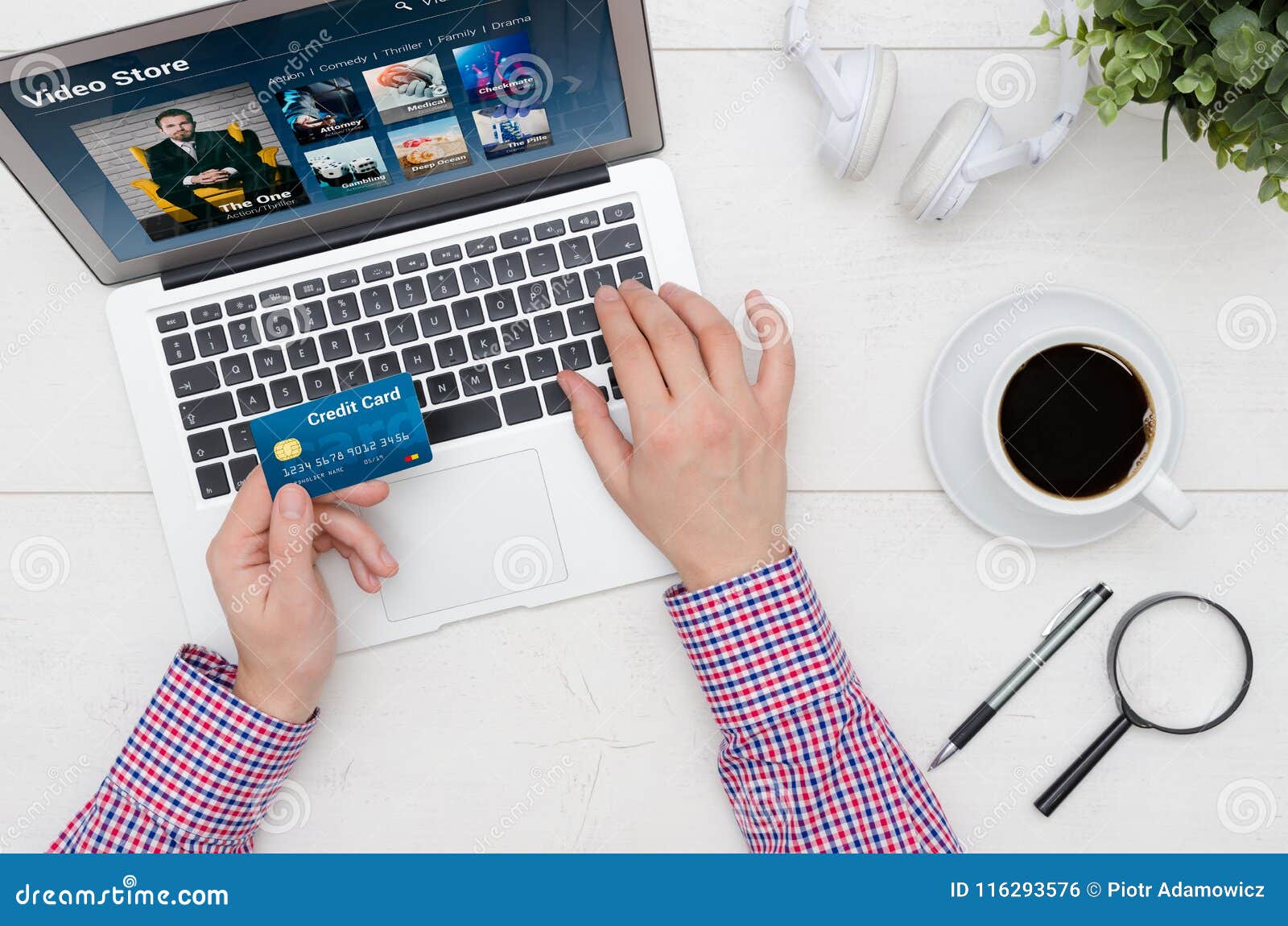 Man Using Credit Card To Pay for Video on Demand Service Stock Photo