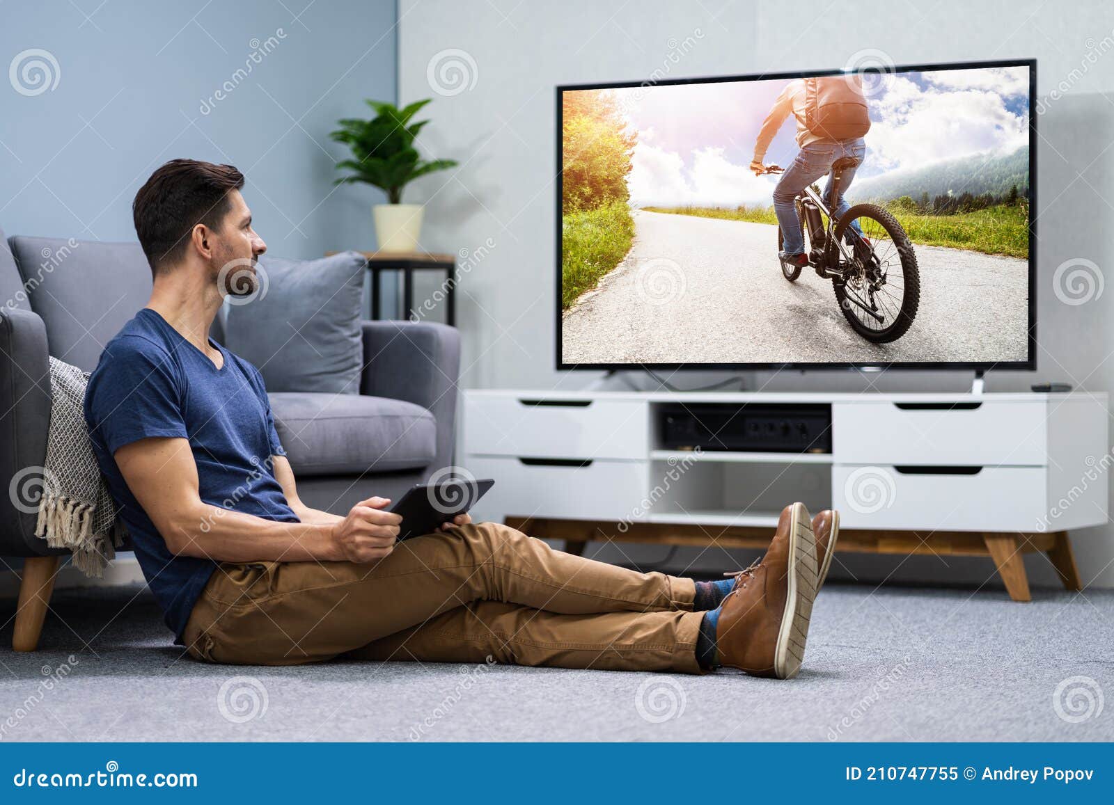 Man Using Digital Tablet for Watching Television Stock Image Image of