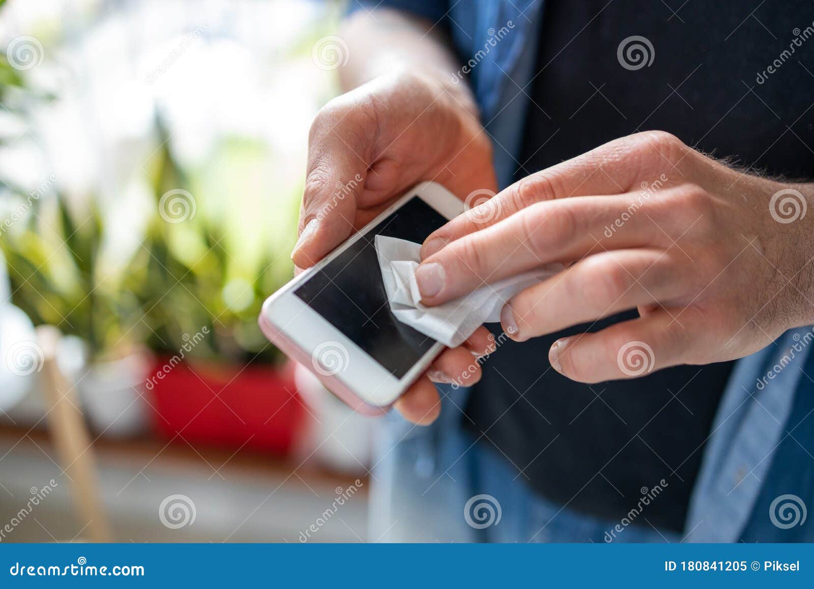 man using a disinfection wipe on a phone