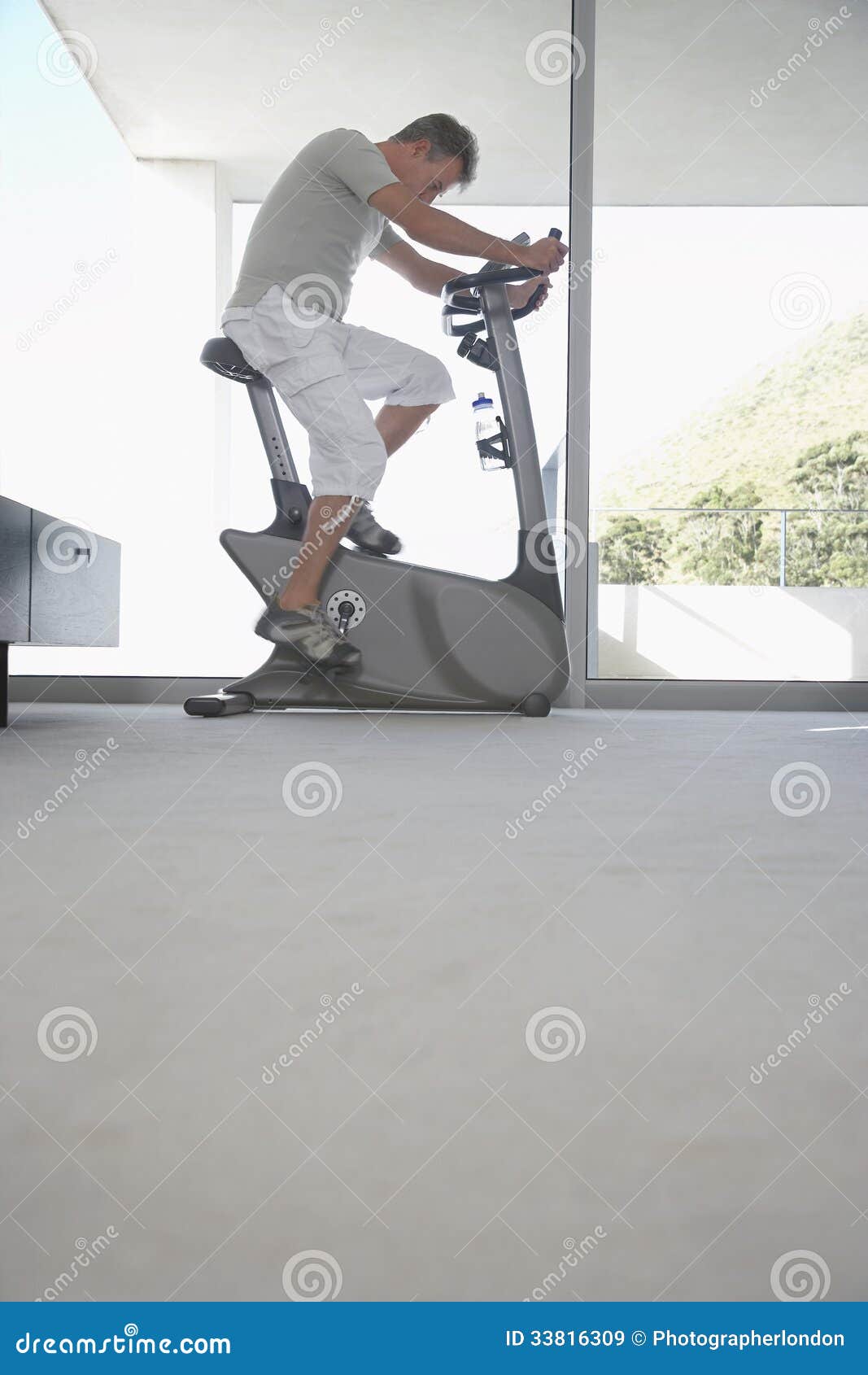 Man Using Exercise Bike at Home Stock Image Image of full, equipment