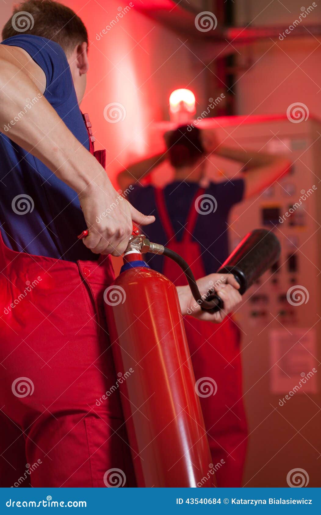 Man Using Fire Extinguisher in Factory Stock Photo Image of dangerous