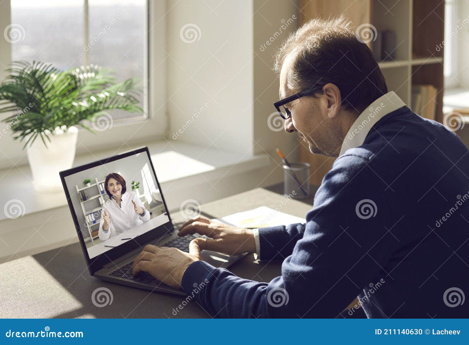 man using his laptop, enjoying virtual visit to clinic and consulting online doctor