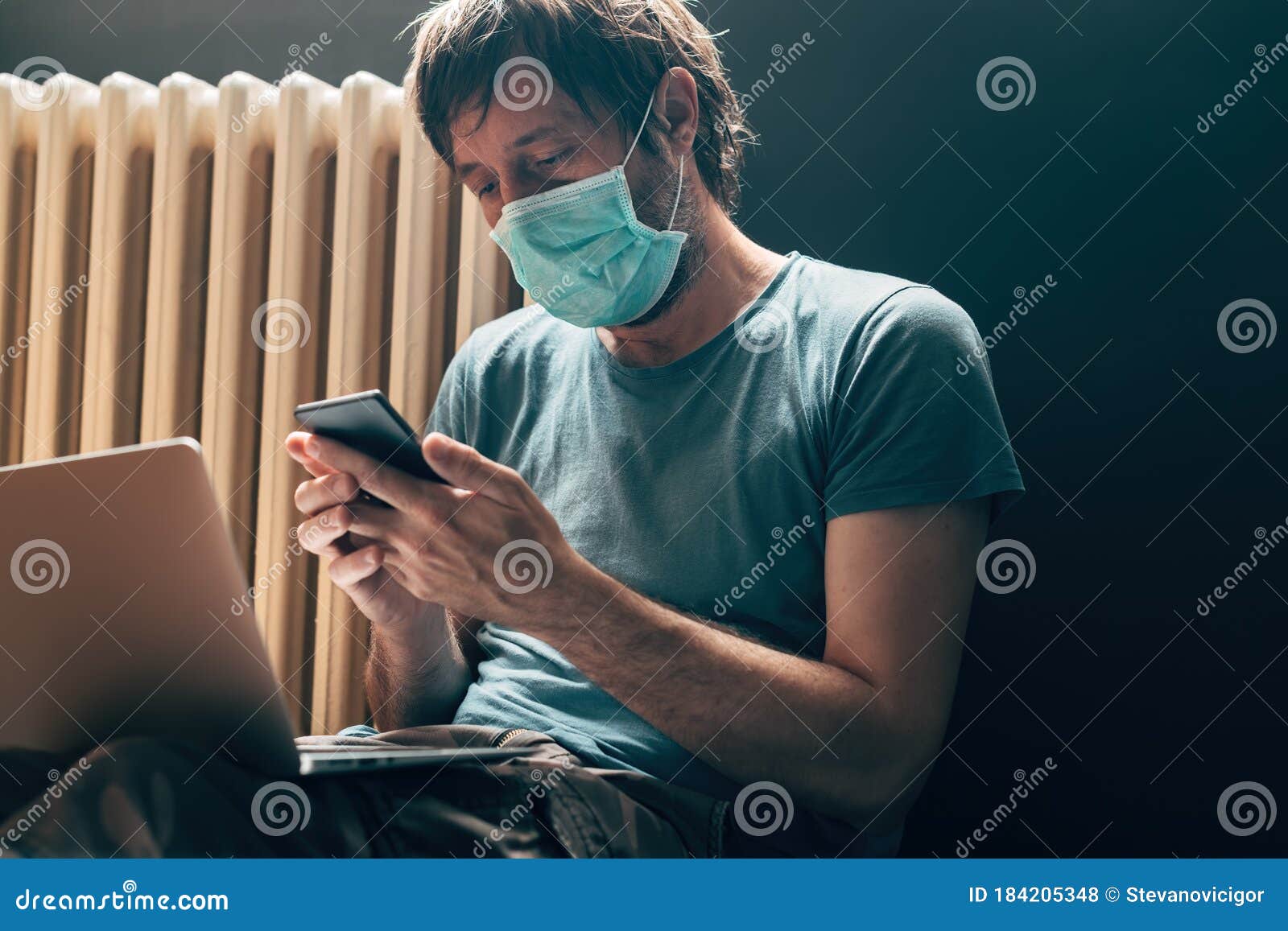 Man Using Laptop Computer and Smartphone in Selfisolation Quarantine