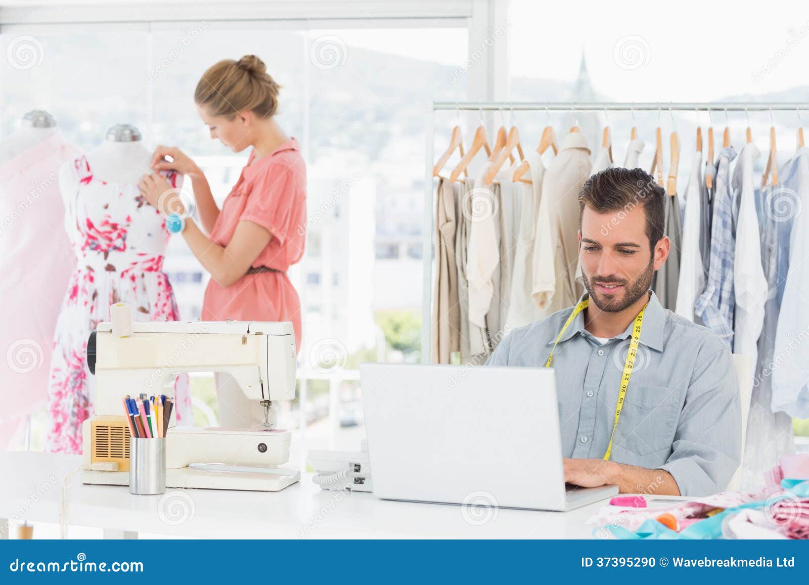 Man Using Laptop with Fashion Designer Working at Studio Stock Photo ...