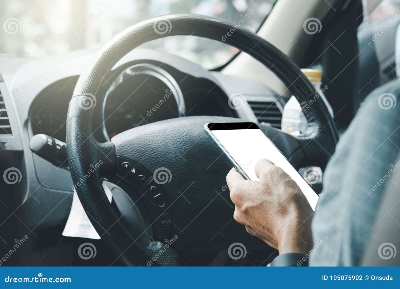 man using mobile phone on car