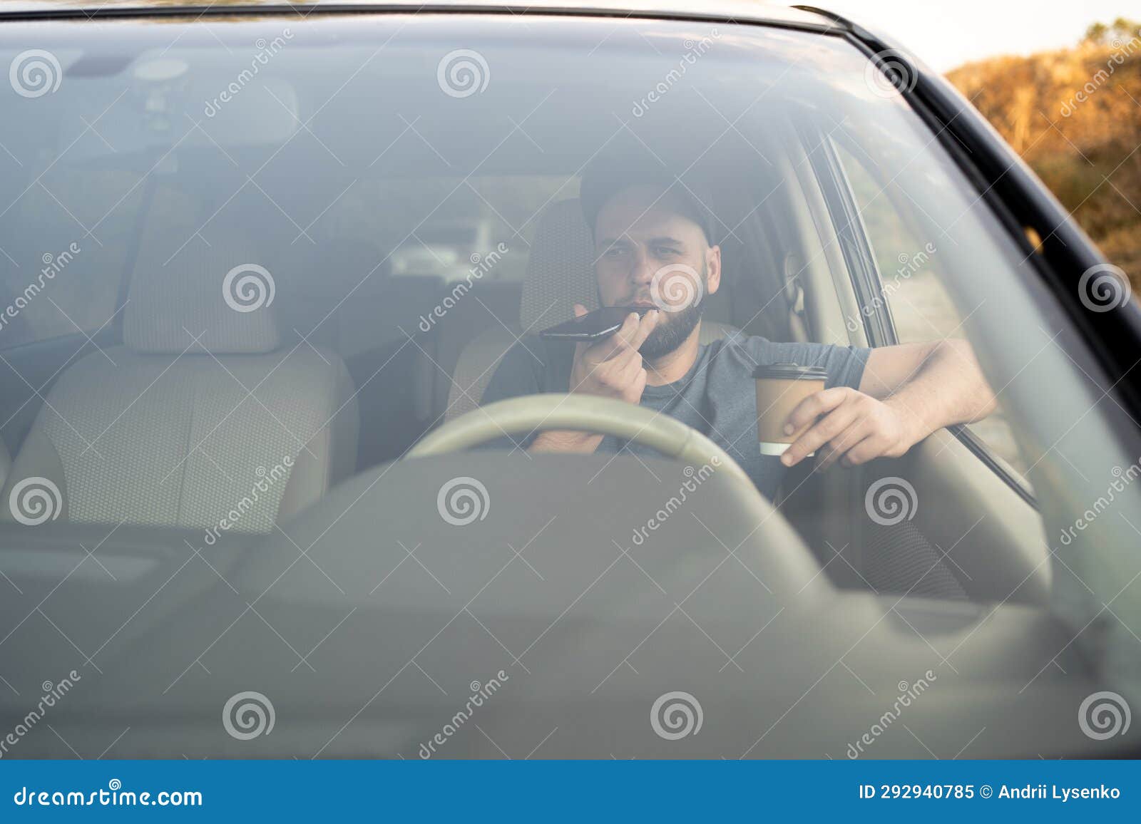 Man Using Mobile Phone, Drinking Coffee and Talking on the Speaker
