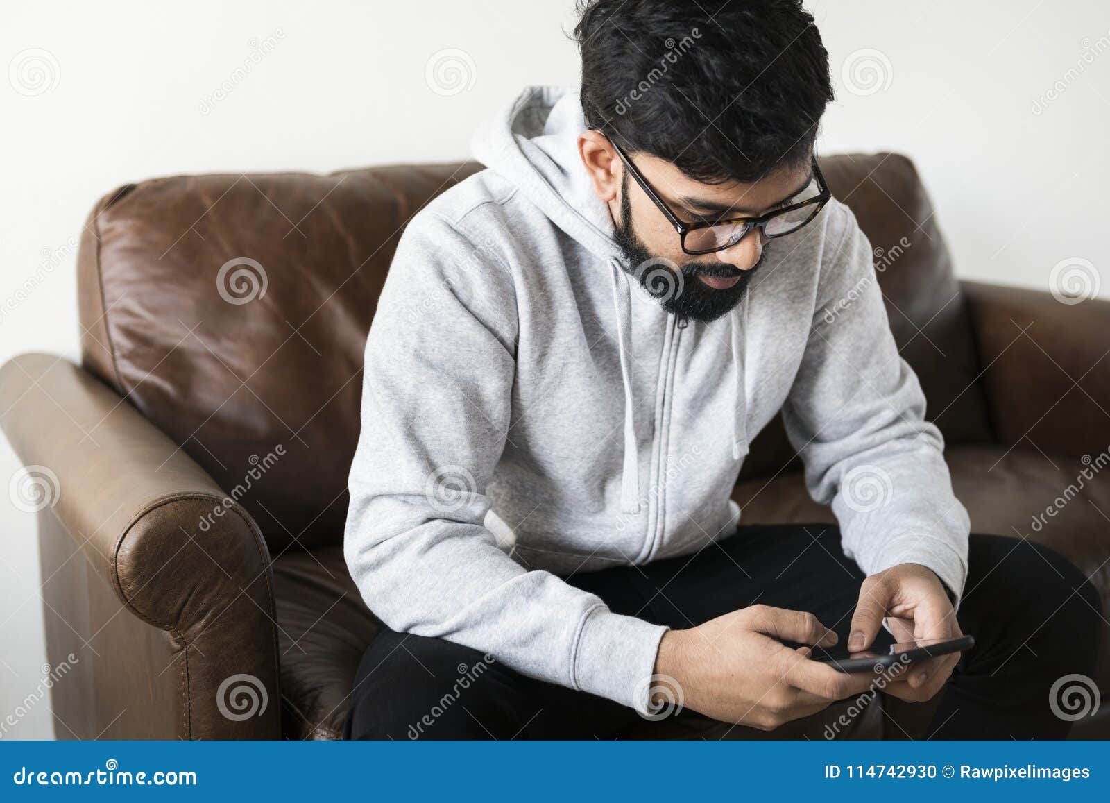 Man Using Mobile Phone Sitting on Couch Stock Photo Image of asian
