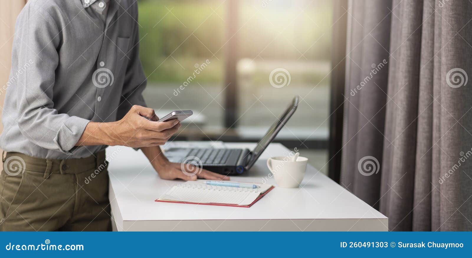 man using mobile phone at workplace at home, freelance concept