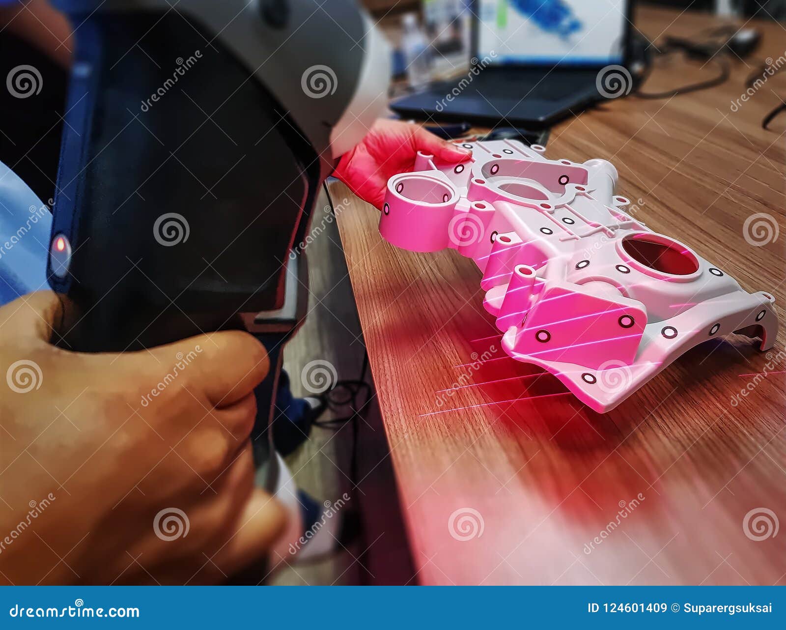 man using portable scanner to scan 3d cad model of complex mechanical part