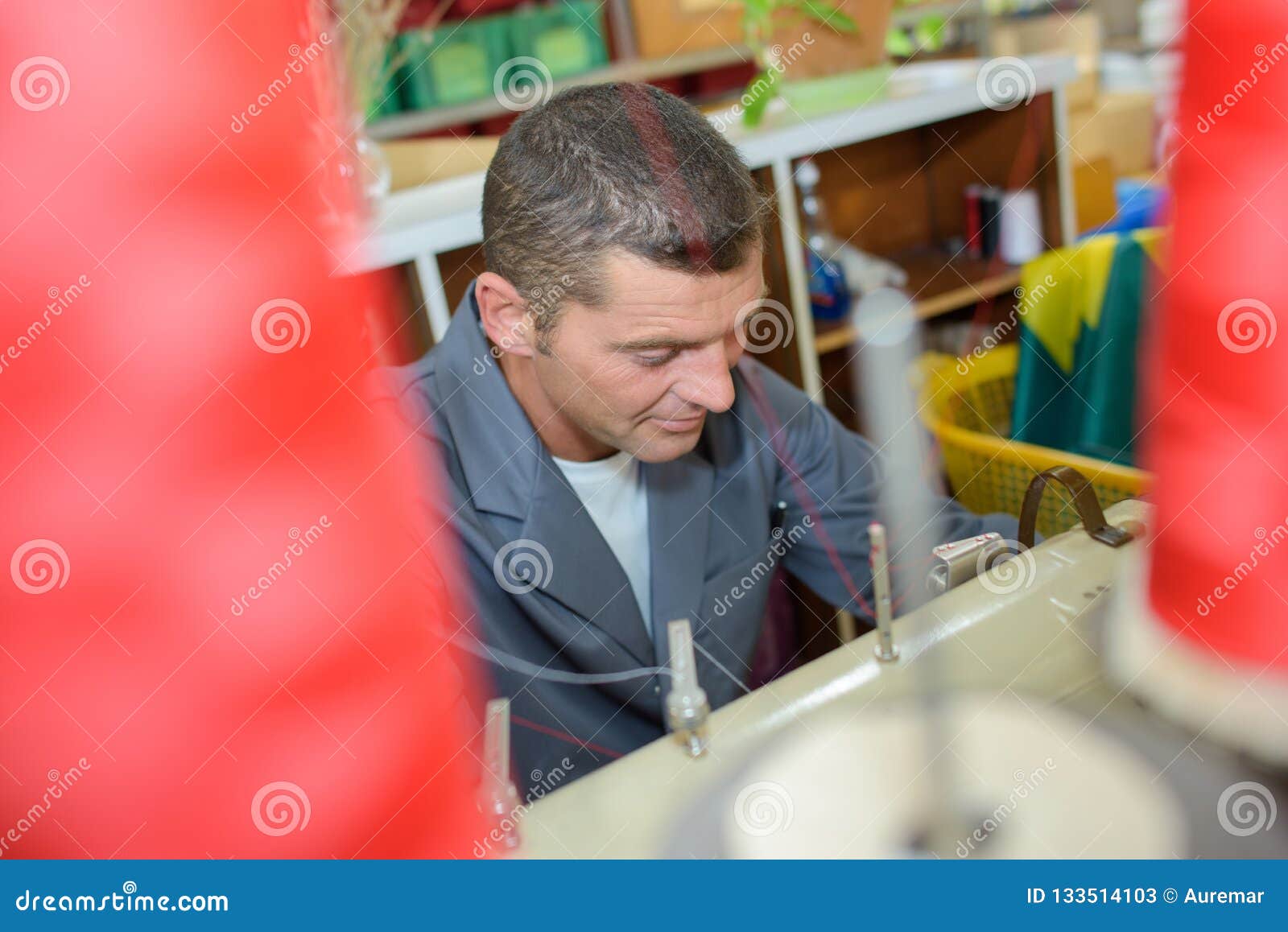 Man using sewing machine stock image. Image of cotton 133514103
