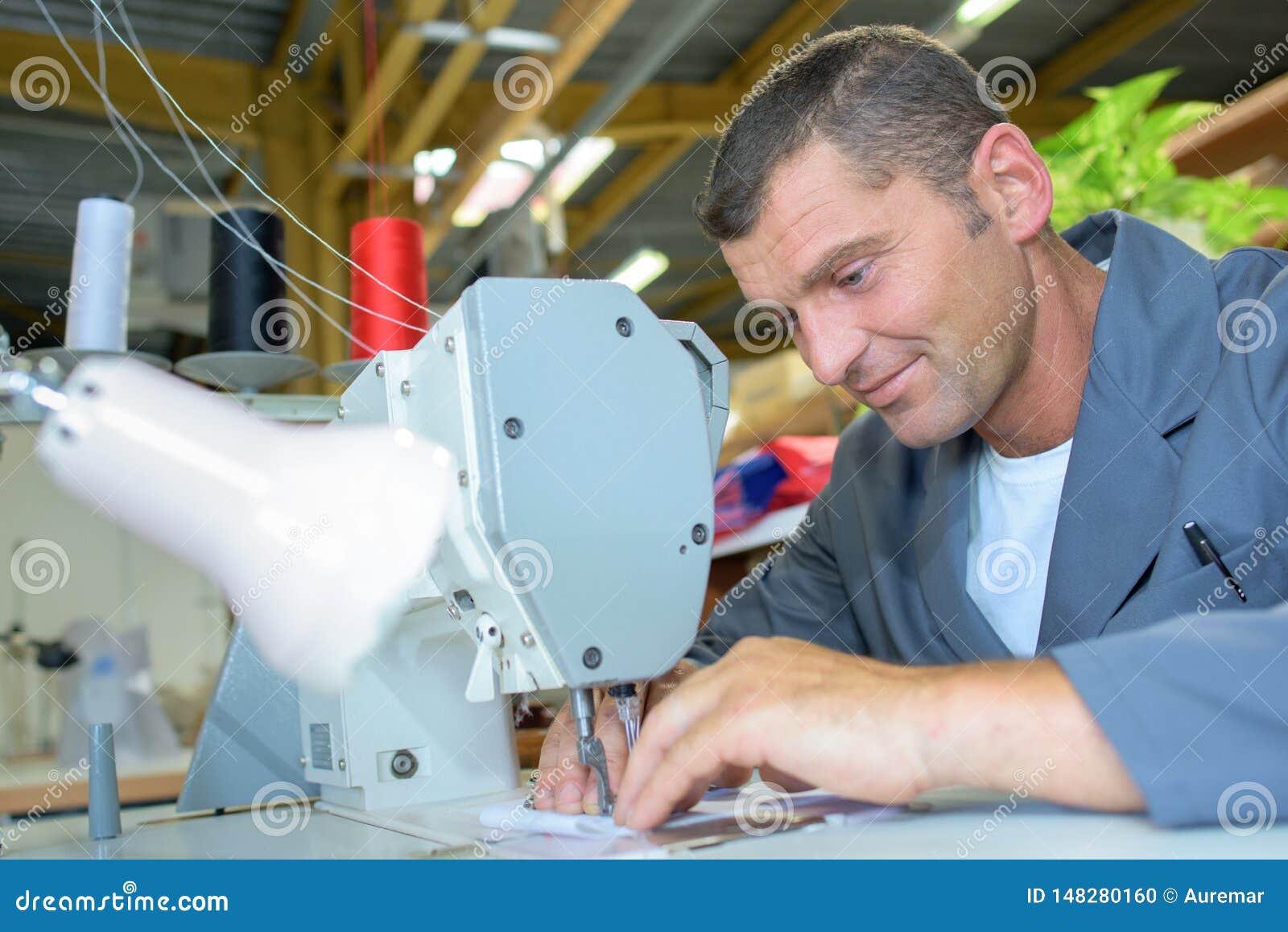 Man using sewing machine stock photo. Image of threads 148280160