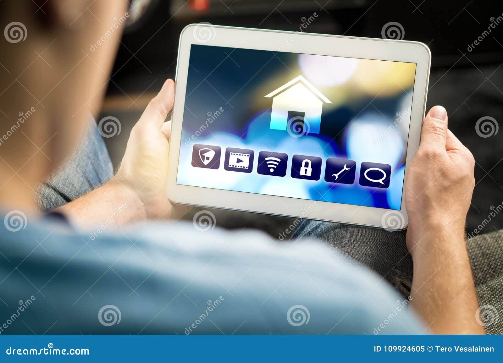 Man Using Smart Home Application in Tablet To Control House Stock Image