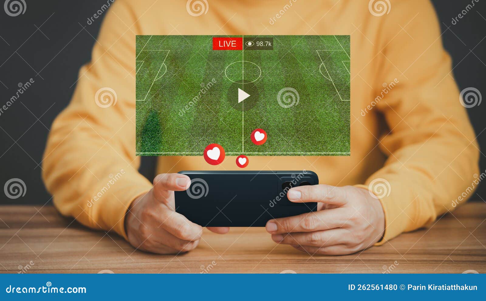 Man Using a Smartphone or Mobile Phone for Watching Live Football Streaming Online on Virtual Screen, Searching Video on Internet Stock Photo