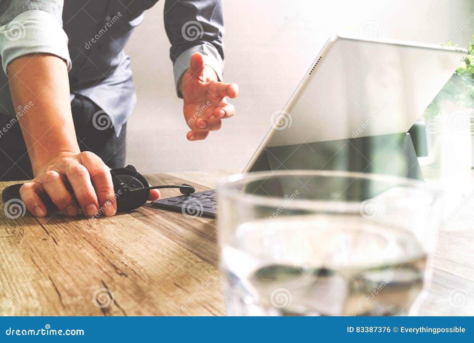 Man Using Voip Headset With Digital Tablet Computer Docking Stock