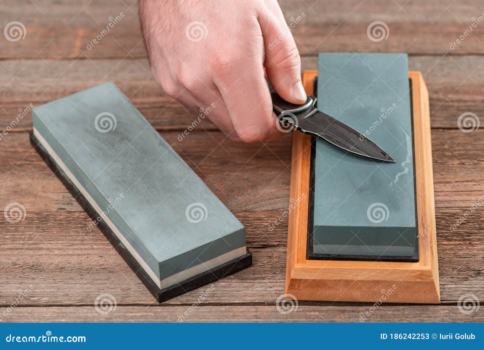 Man Using A Whetstone To Sharp His Pocket Knife RoyaltyFree Stock