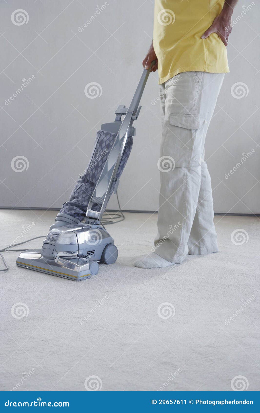 Man Vacuuming Cleaner stock image. Image of casual, chord 29657611