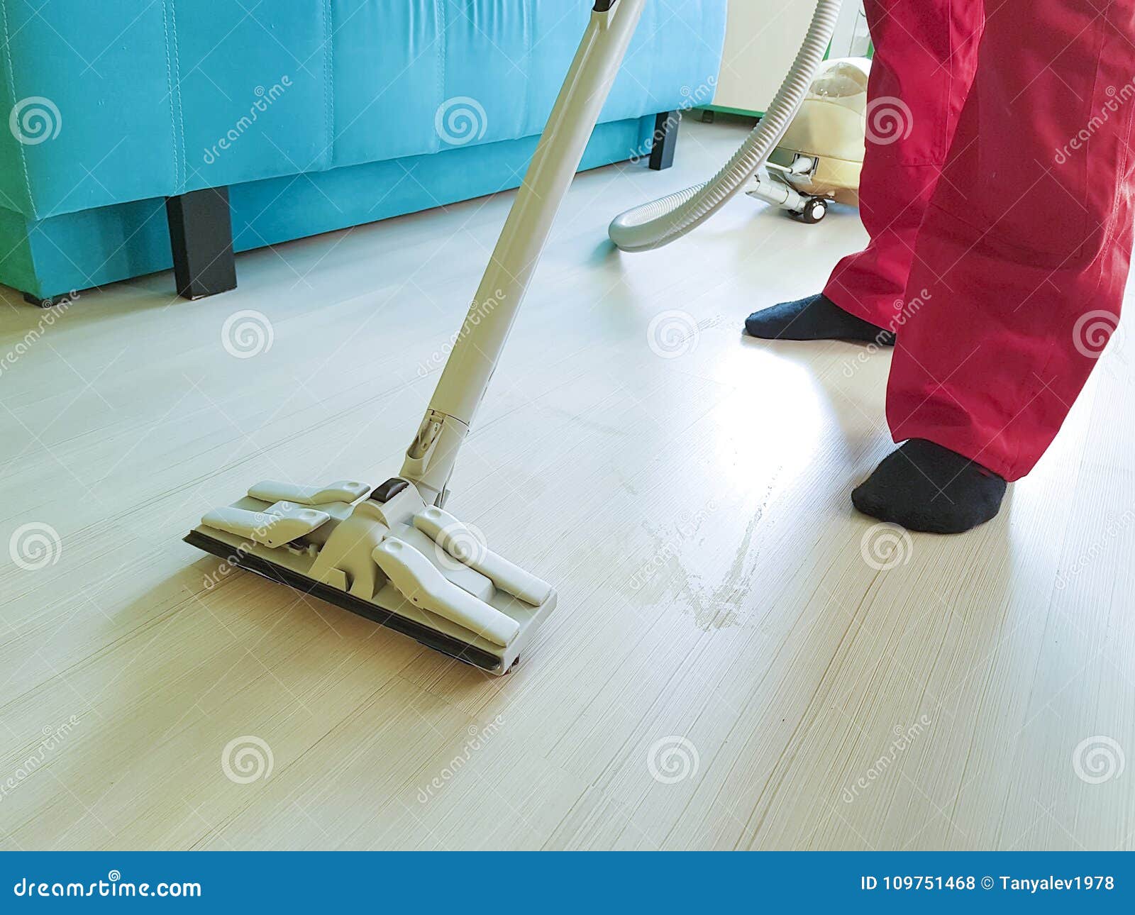 Man Vacuuming The Floor In The Household Room Keeping Equipment