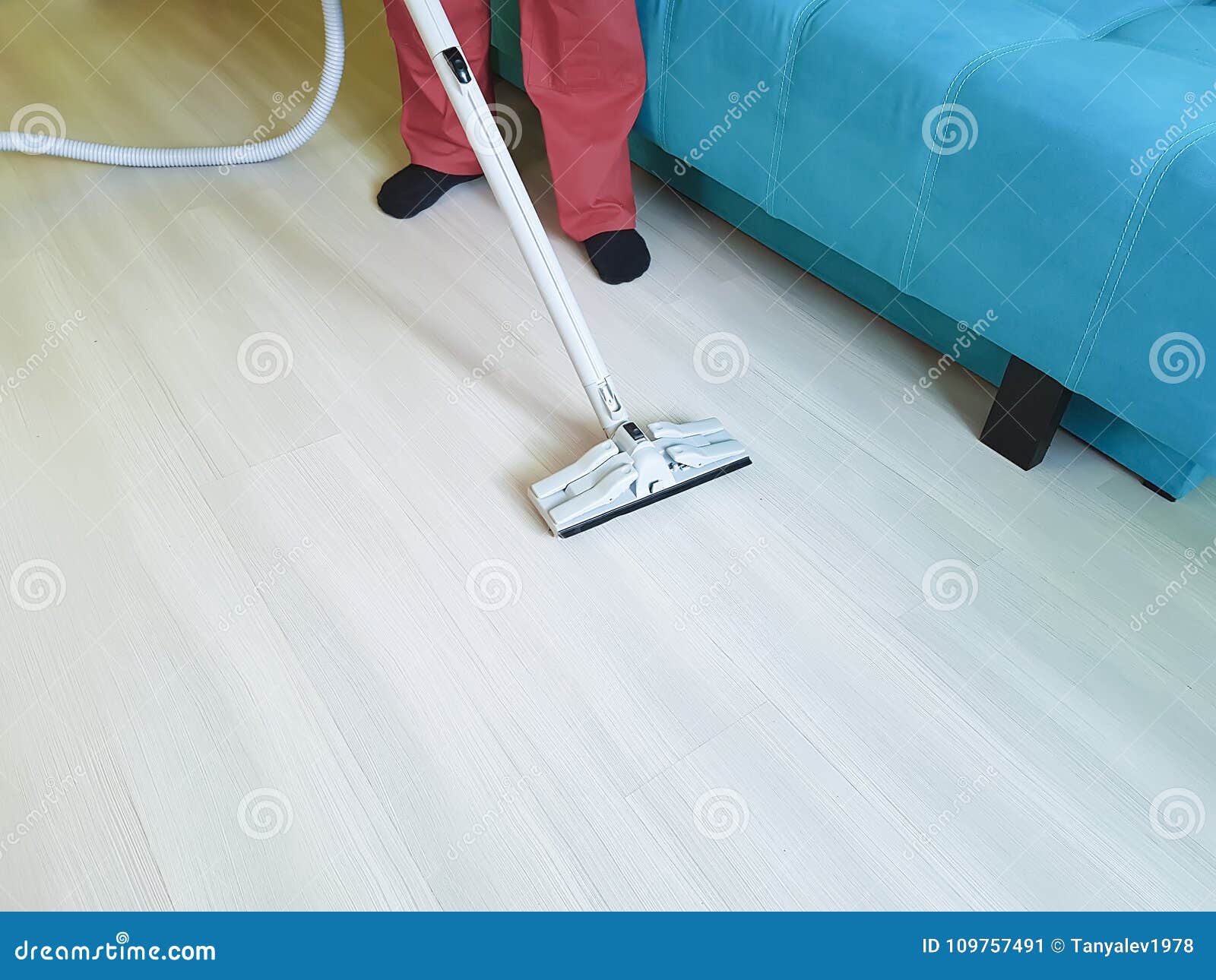 Man Vacuuming The Floor In The Room Equipment Cleaning Service