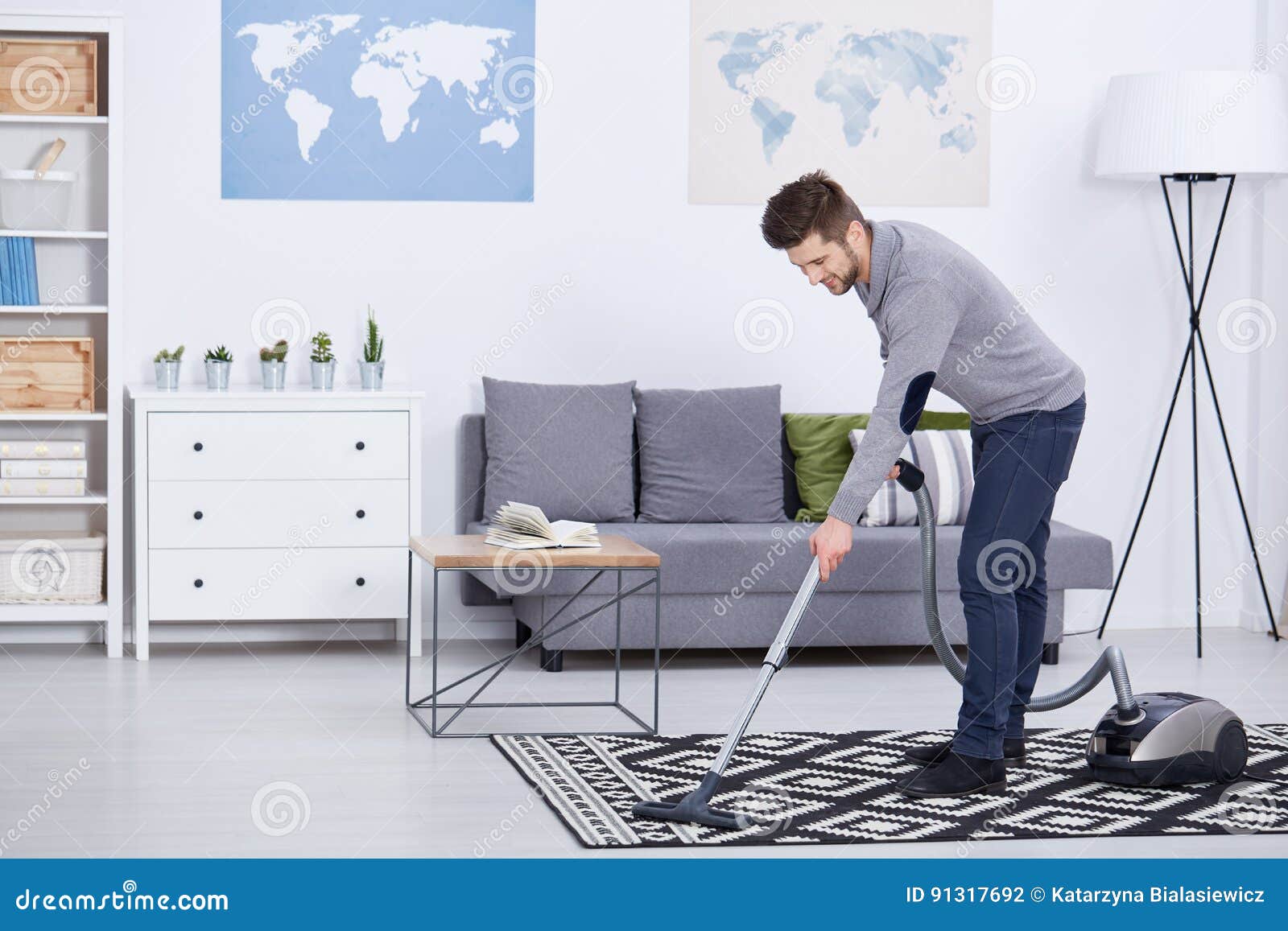 man vacuuming in a living room