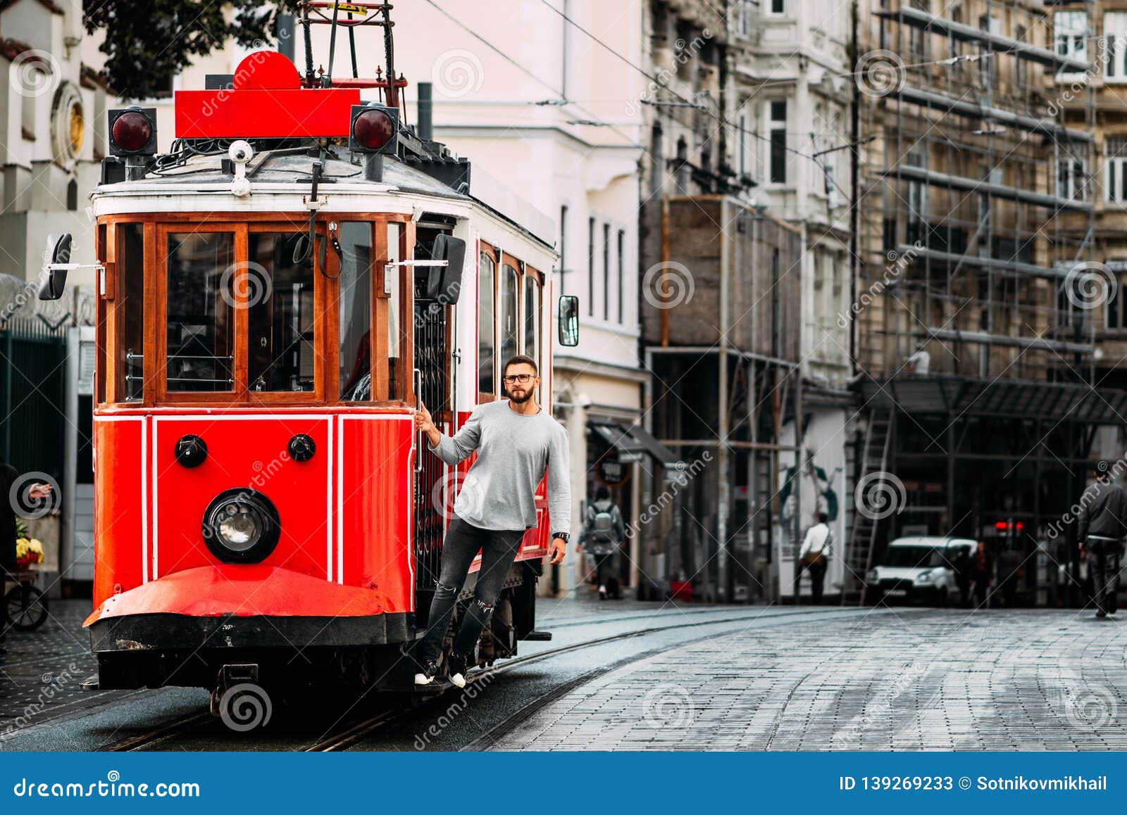 man in a vintage tram on the taksim istiklal street in istanbul. man on public transport. old turkish tram on istiklal street,