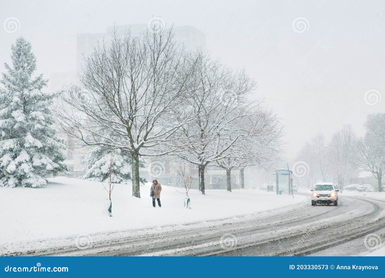 man walking under snow. heavy snowfall and snowstorm in toronto, ontario, canada. snow blizzard and bad weather winter condition.