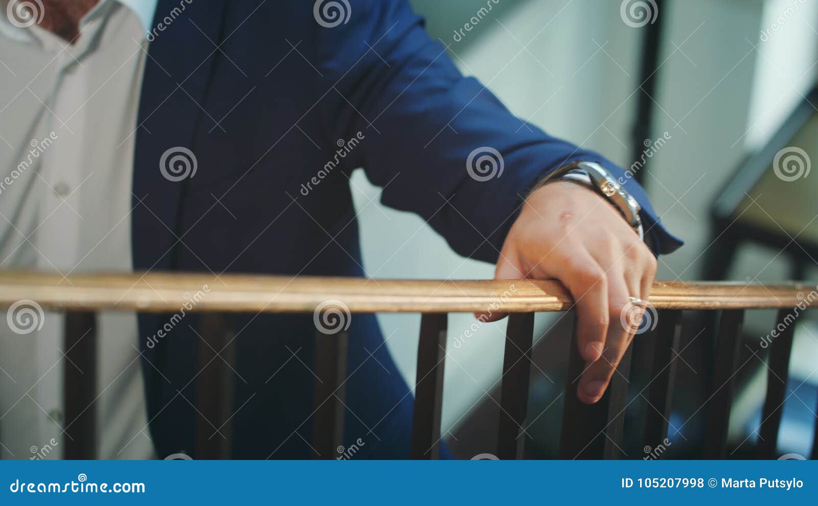 a man walking up the stairs holding the bannister