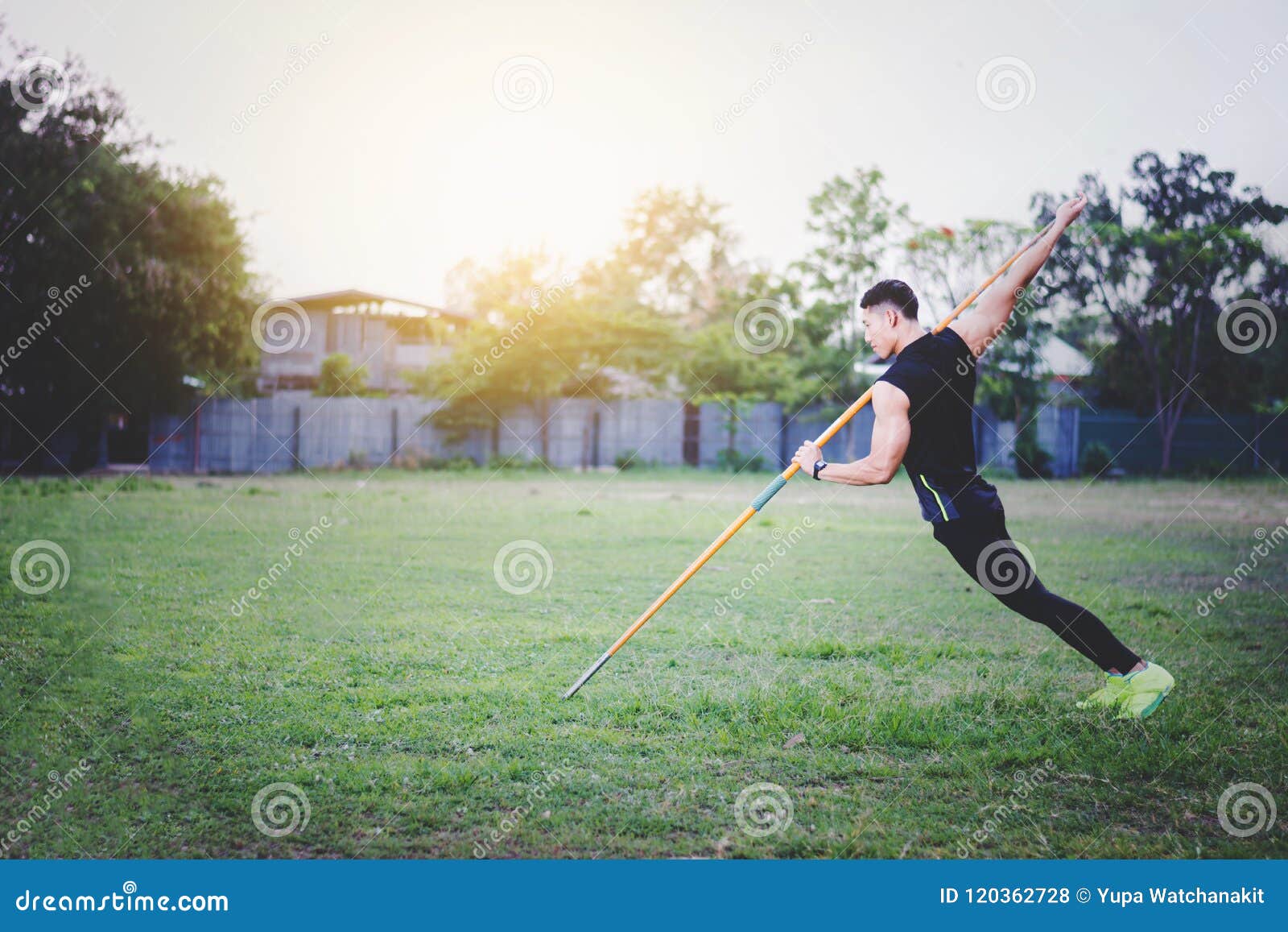 Man Warming Up and Practicing Javelin Throw in Yard Stock Photo Image