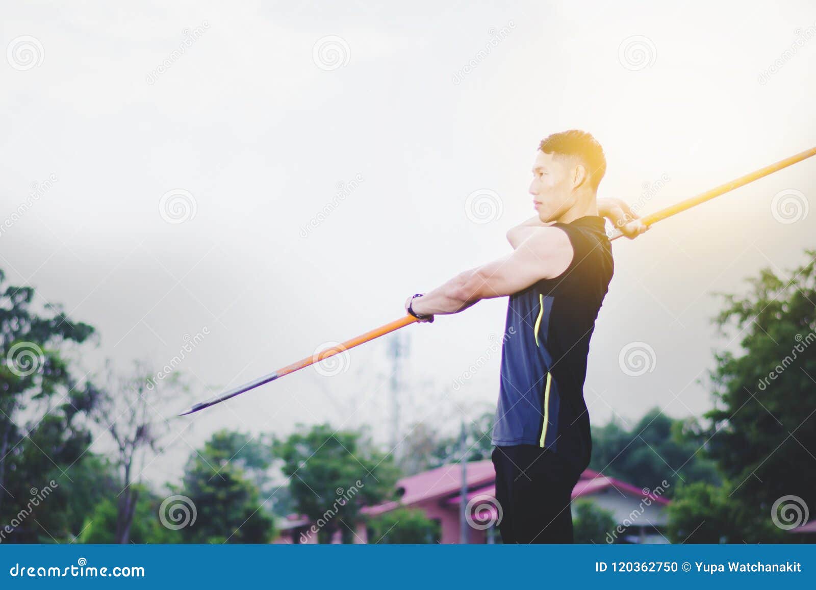 Man Warming Up and Practicing Javelin Throw in Yard Stock Photo Image