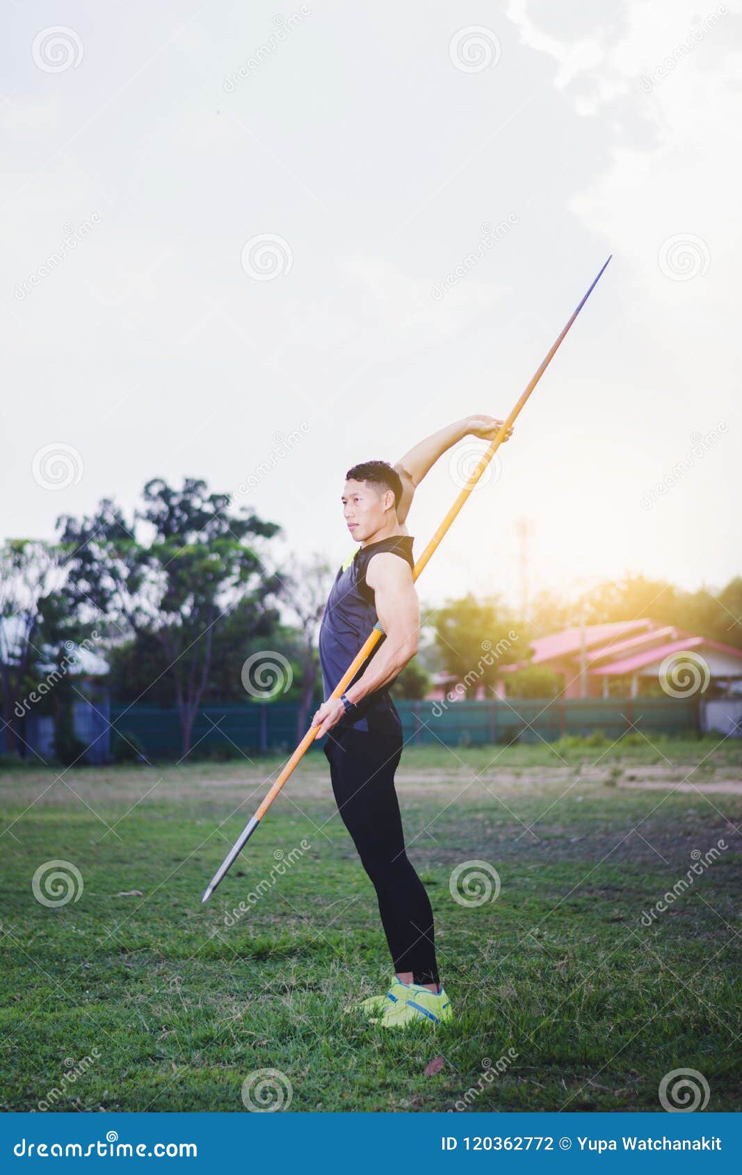 Man Warming Up and Practicing Javelin Throw in Yard Stock Photo Image