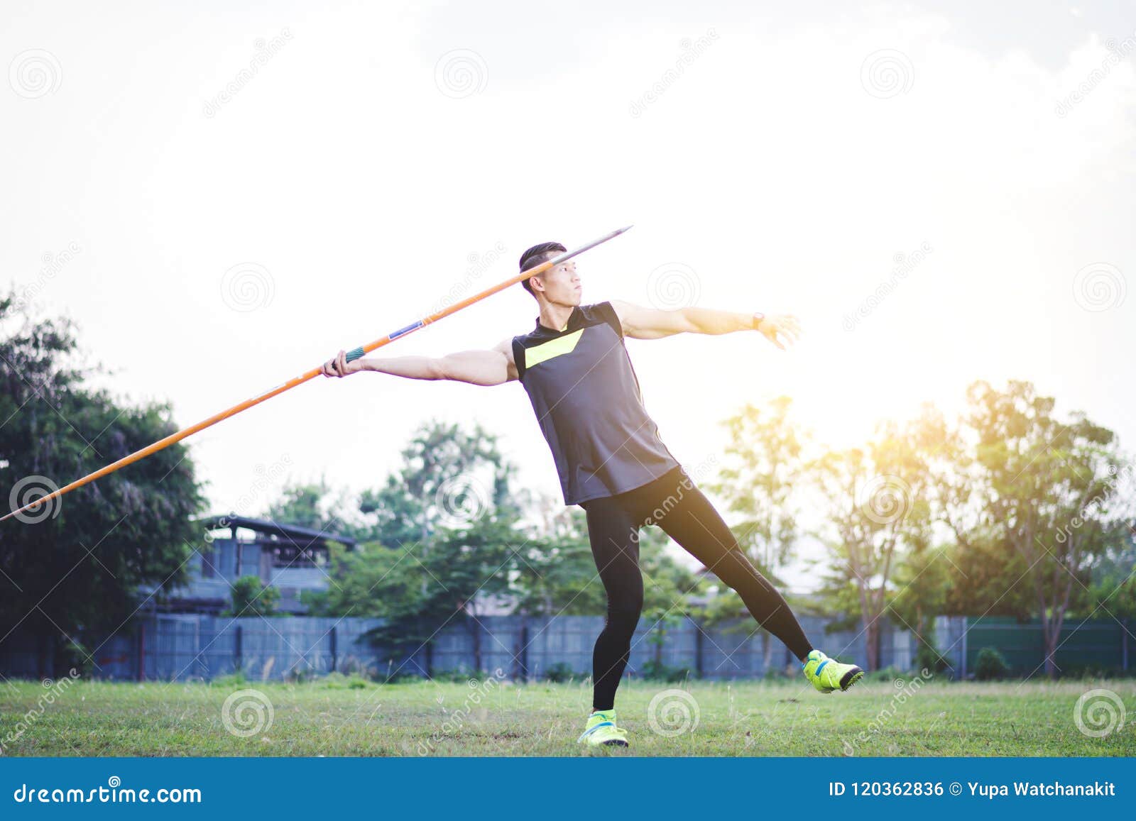 Man Warming Up and Practicing Javelin Throw in Yard Stock Photo Image