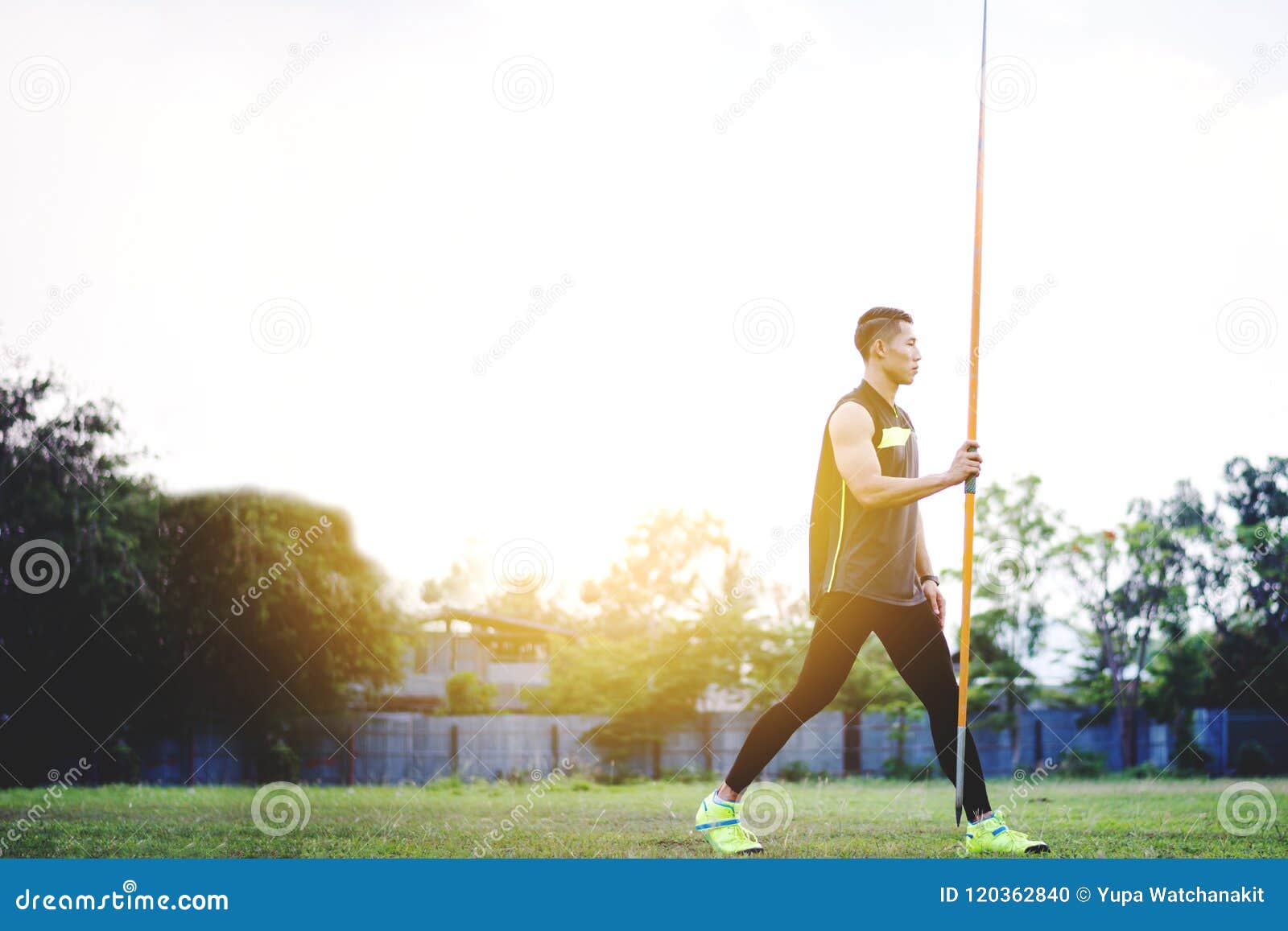 Man Warming Up and Practicing Javelin Throw in Yard Stock Photo Image
