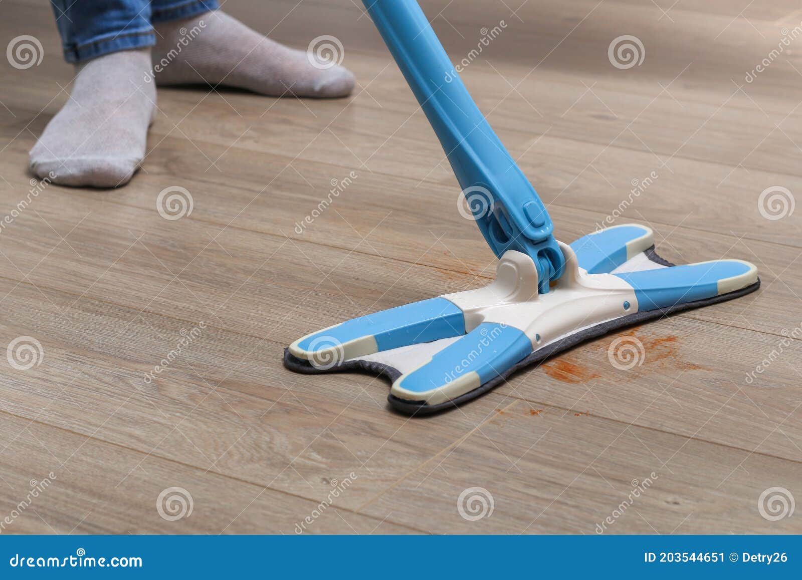 A Man Washes the Floors with a Mop in Room. Under the Bed. Cleaning