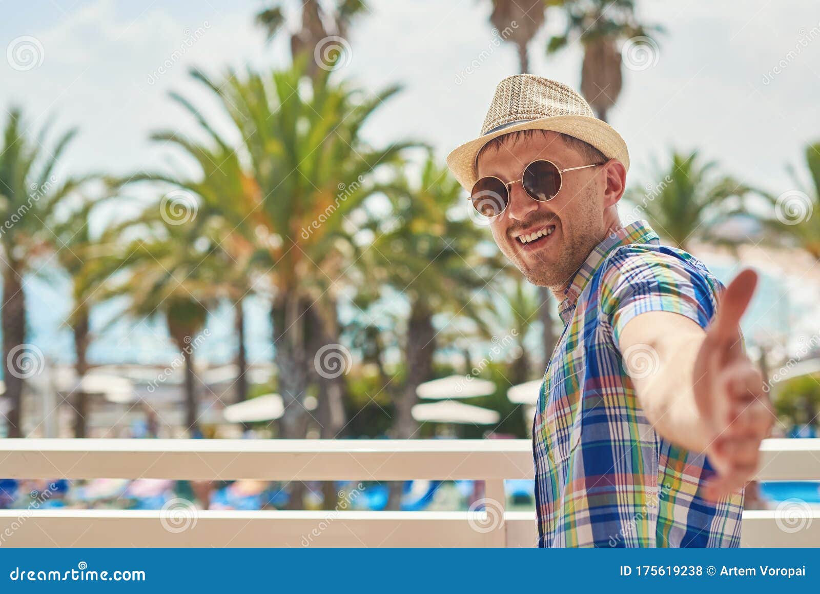 man in watching to camera while holding his arms wide open against amazing view