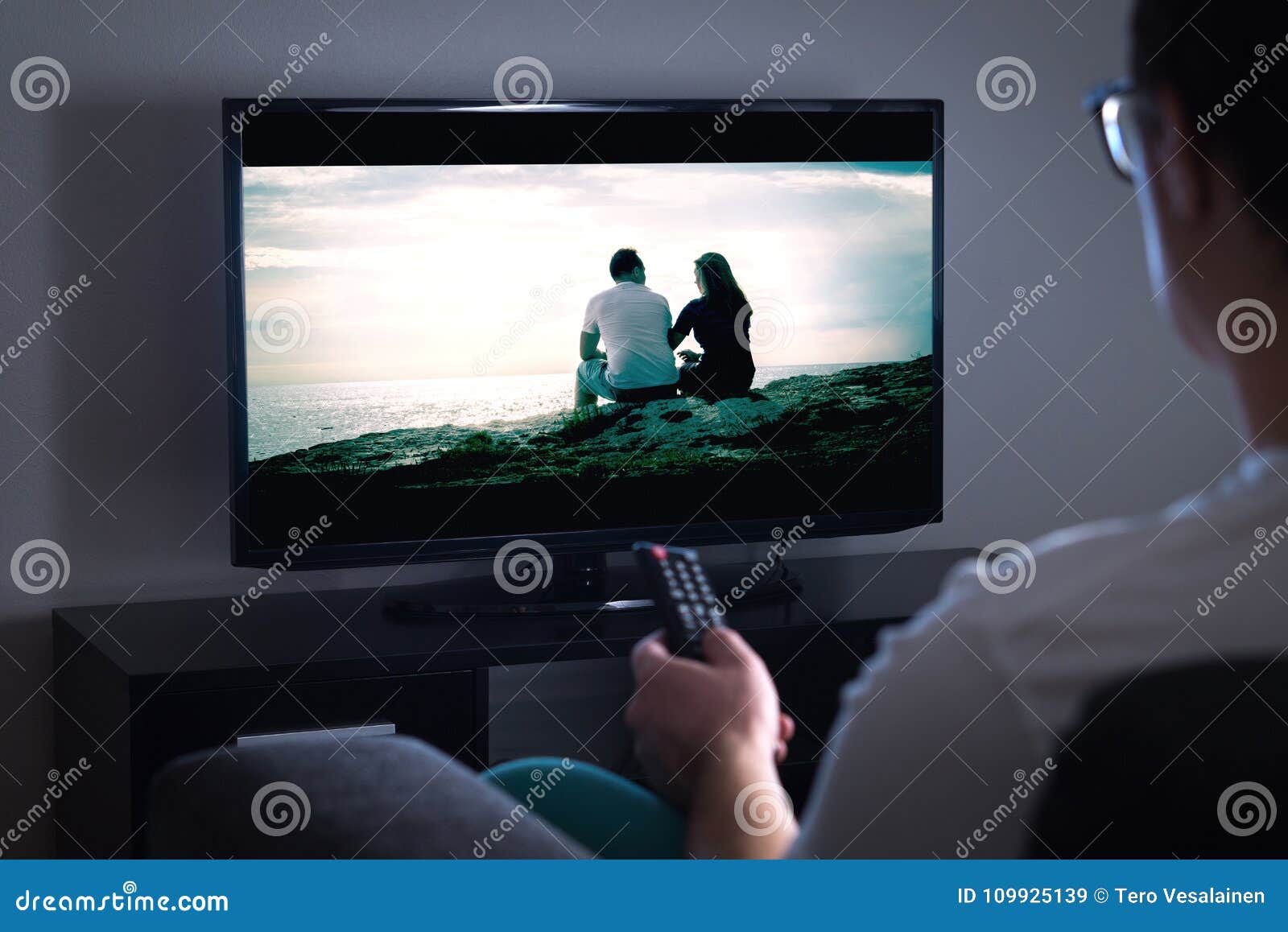 man watching tv or streaming movie or series with smart tv