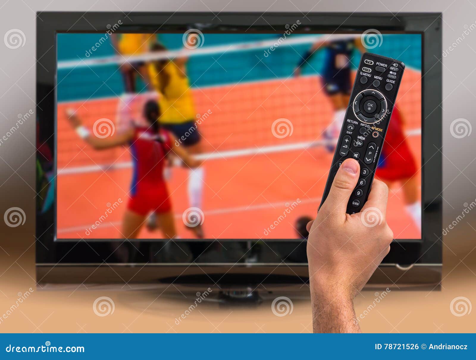 Man is Watching Volleyball Match on TV Stock Photo