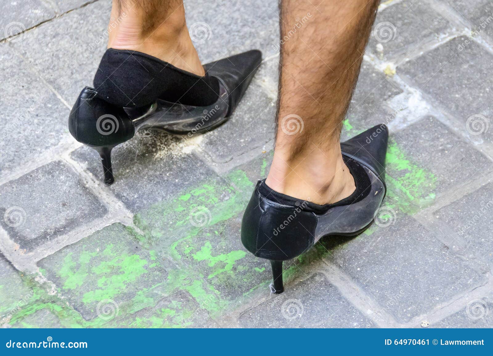 Woman in red high heels stepping on a shrunken man Stock Photo - Alamy