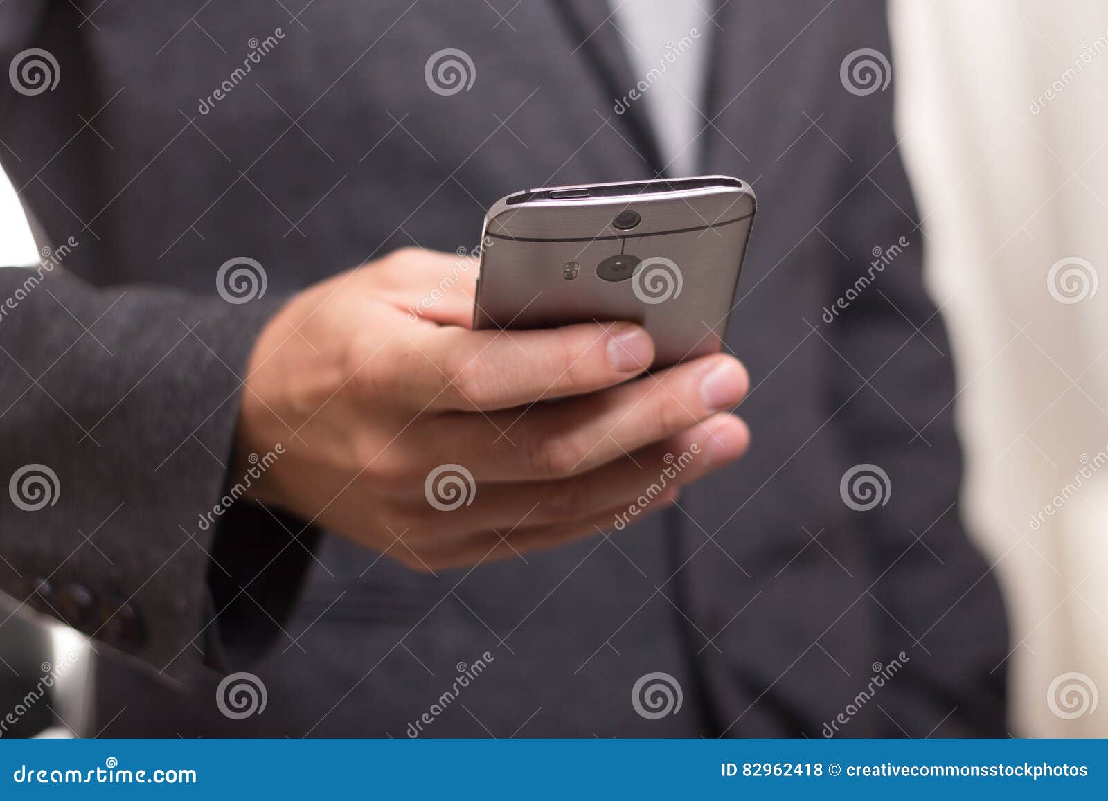 Man Wearing Black Suit Jacket Holding Gray Htc Android Smartphone ...