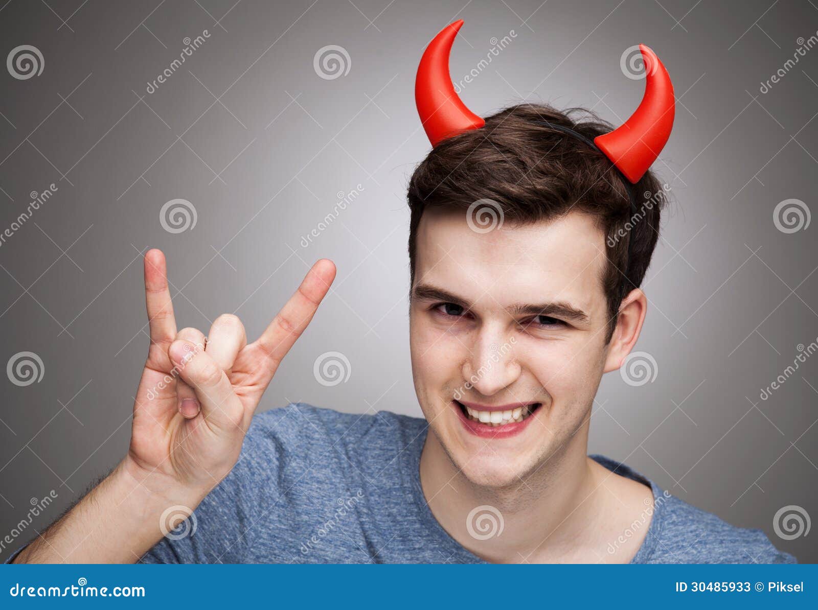 Man wearing devil horns stock image. Image of gesturing 30485933