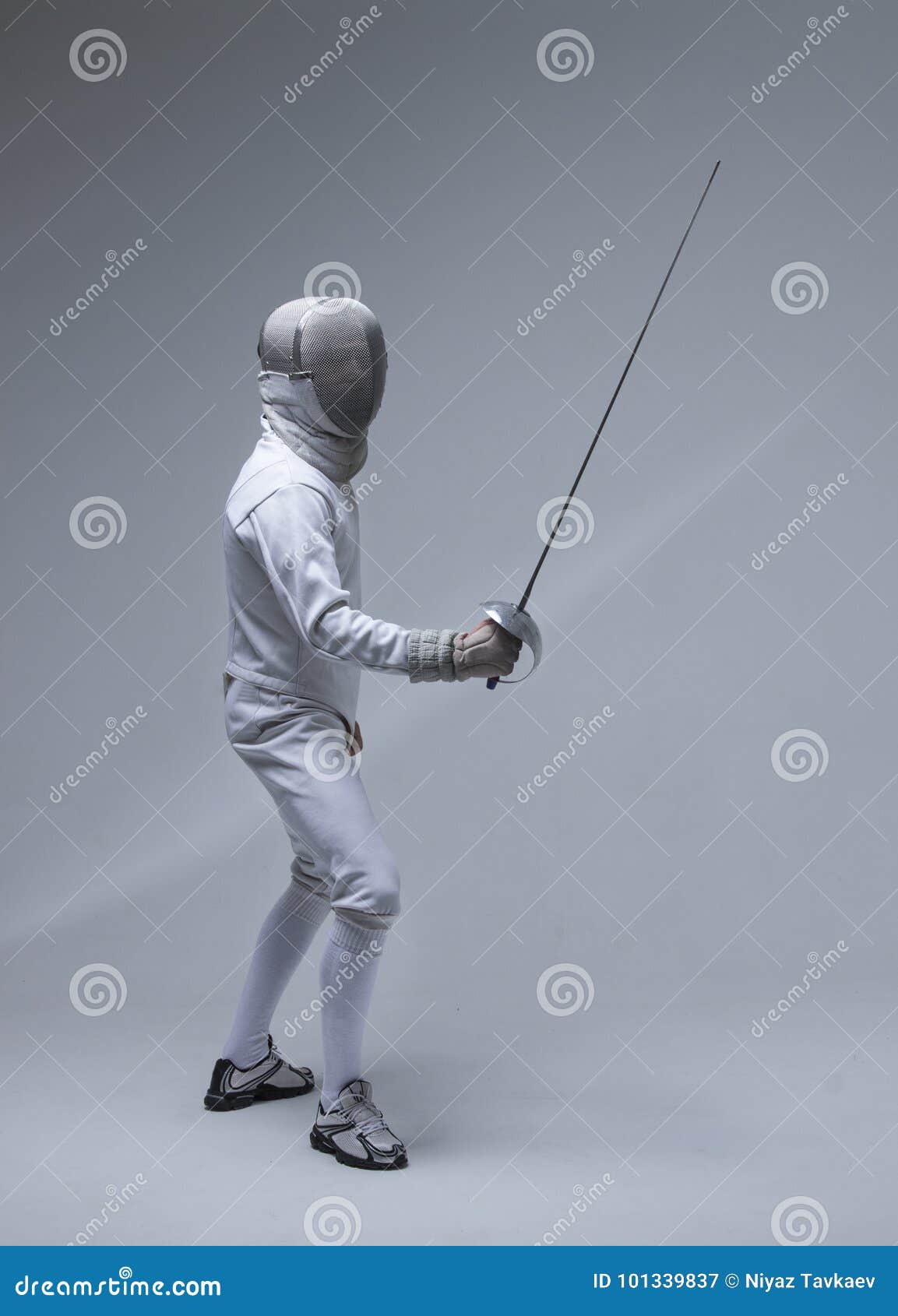 man wearing fencing suit practicing with sword