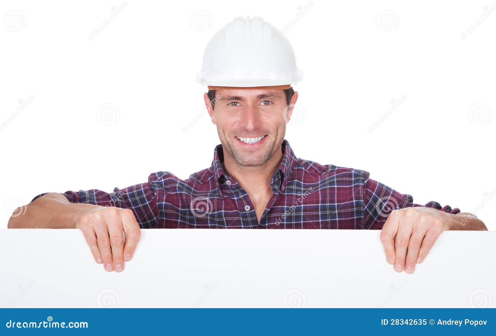 man wearing hard hat holding placard