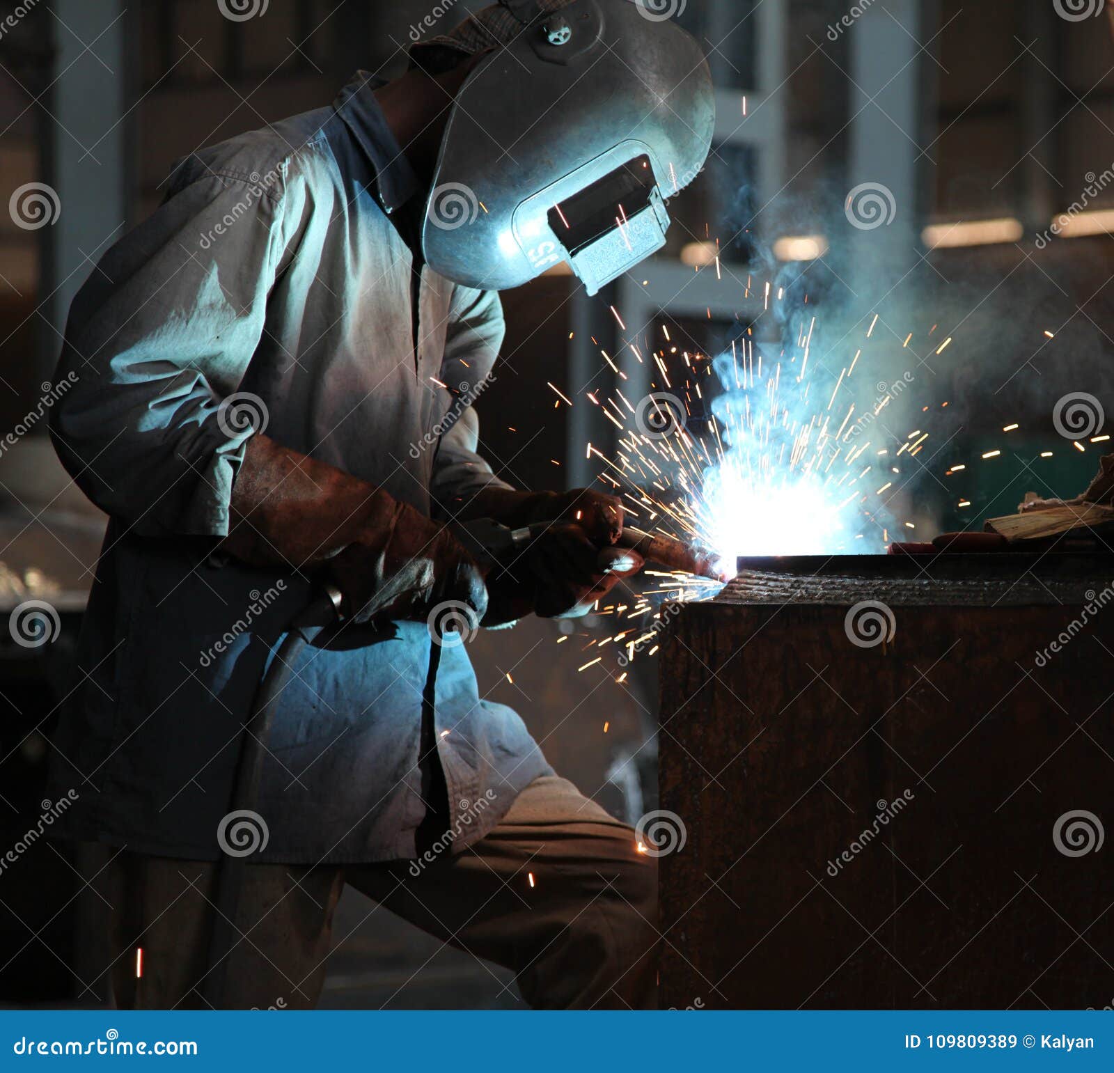 man welding sheet matal using arc welding